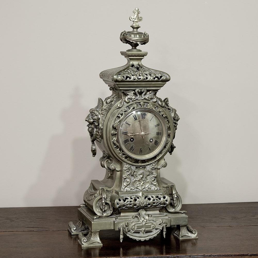 Cast from solid bronze in the timeless Renaissance style, this impressive 19th century mantel clock is perfect for centering in front of a mirror. The pierce work makes for visual intrigue, and the enameled Roman numerals add a nice touch. Examine