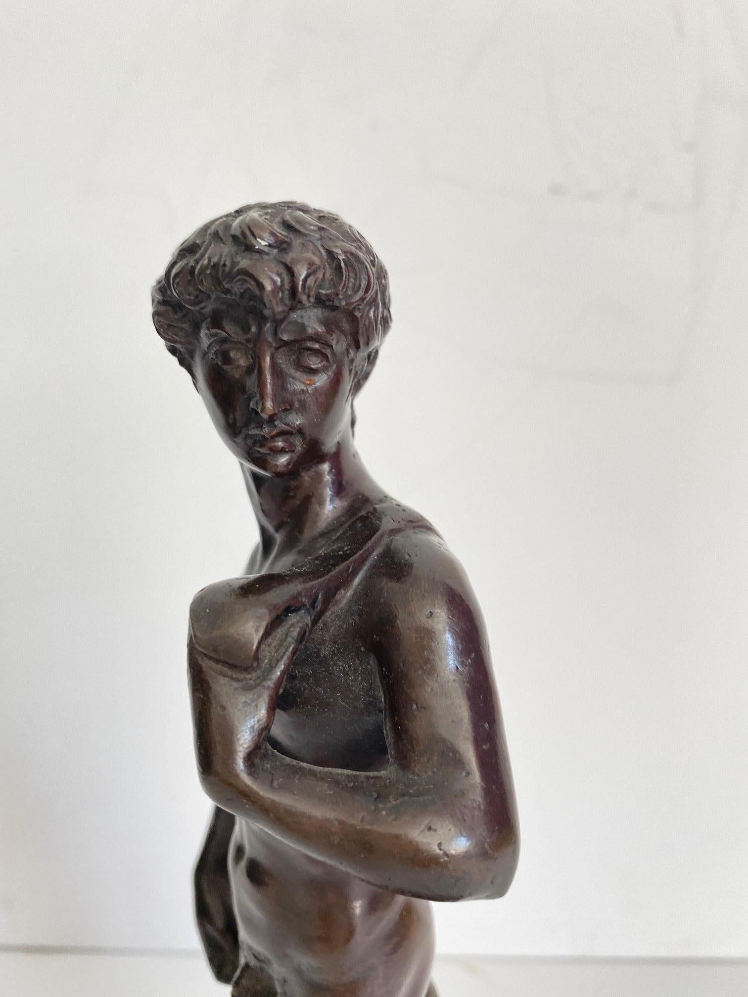A 19th-century Roman bronze figure. The bronze is raised by a rectangular mottled edge black Belgian marble base below a thick rectangular Rosso Levanto support. Rich detail with a warm and rich patina throughout.