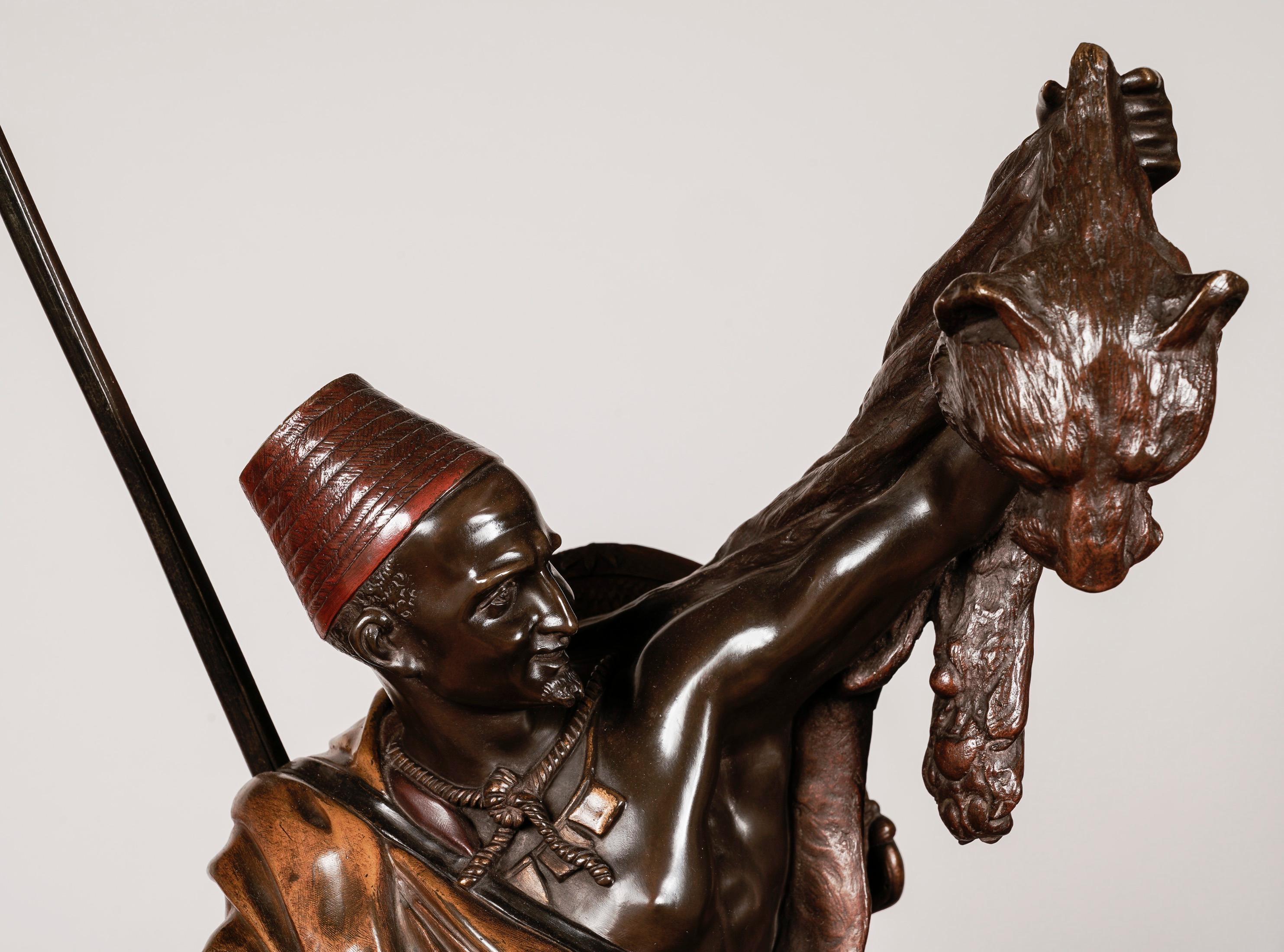 Kabyle au retour de la chasse
By Arthur Waagen

A rare example retaining its original cold-painted details in harmony with the patinated bronze; the impressive model of an Arab huntsman on horseback, holding up a lion's pelt while securing a