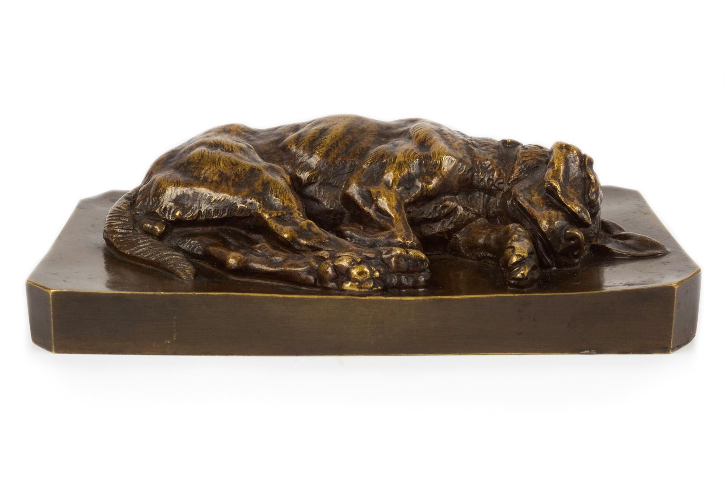 A fine sand-cast model of a sleeping basset hound by animal painter and sculptor Jean-Baptiste-Louis Guy, it exhibits an overall medium brown surface patina with a complex variety of hues and intensity ranging from nearly black in recesses to nearly