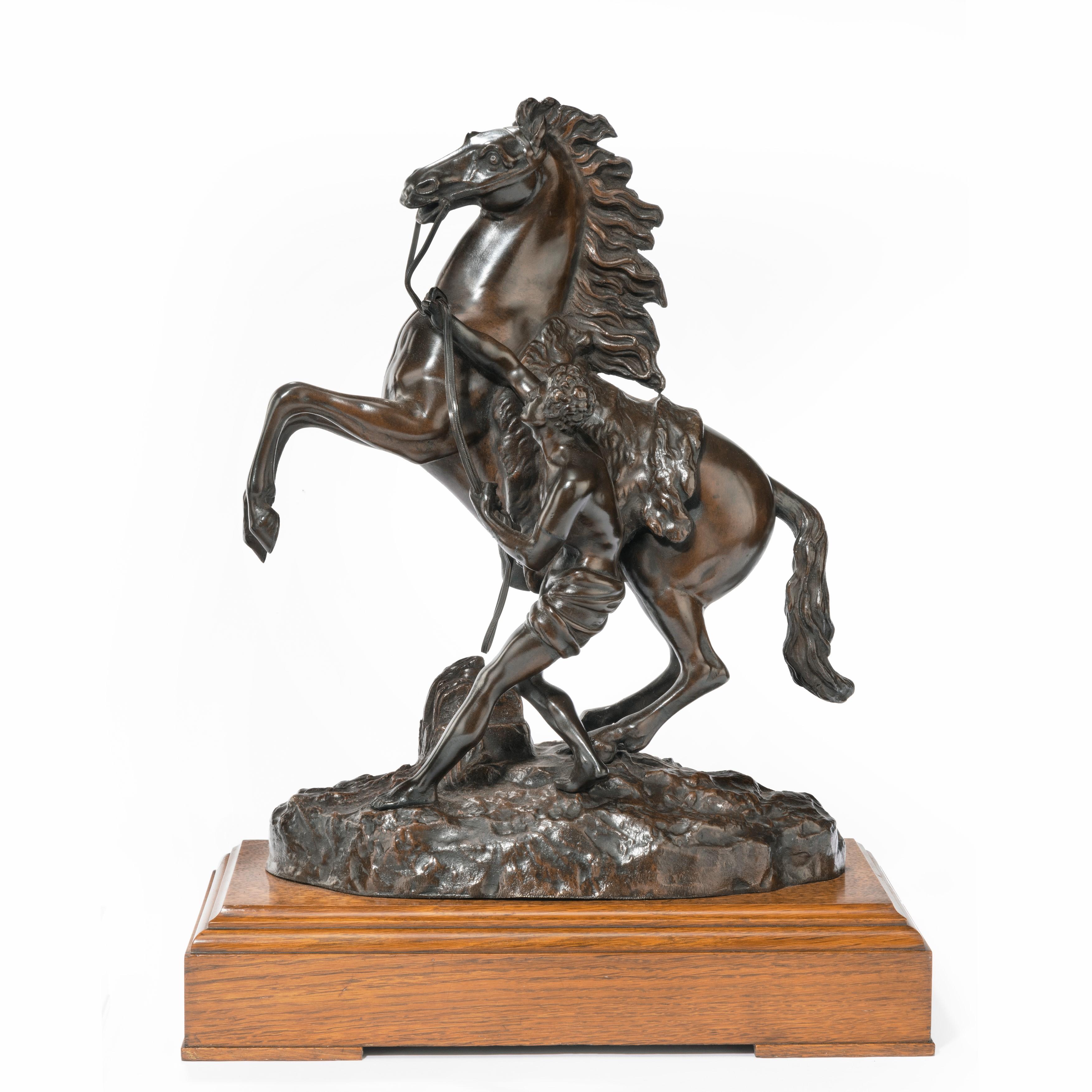 A good pair of 19th century bronze sculptures of the Marly horses, each showing a rearing wild horse with a flying mane, bridle and saddle-cloth being restrained by a groom, incised ‘Coustou’, on polished oak bases. French, circa 1900.

Footnote:
