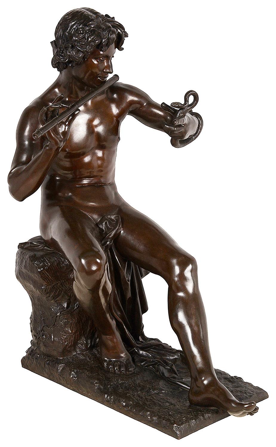 Handsome nude male snake charmer seated and playing a flute while holding the snake, gazing at it and watching it move. The sculpture has a beautiful patina signed A. Thabard. 
Thabard ( Adolphe Martial Thabard, important French listed sculptor