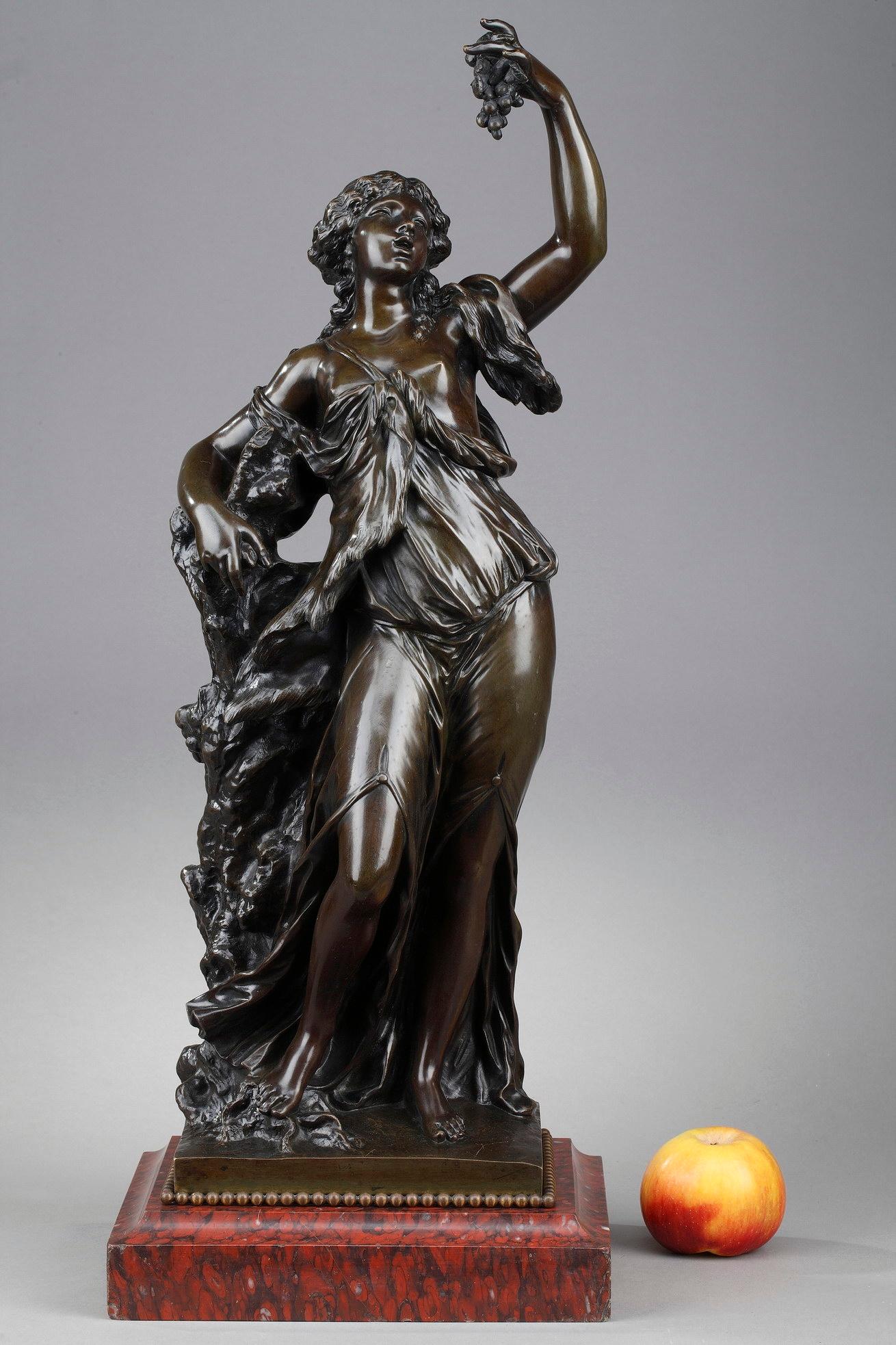 This statue featuring a Bacchante is crafted of patinated bronze. In Roman mythology, Bacchae, or Bacchantes, were the female followers of Bacchus. They were often depicted in the company of Satyrs, dancing, playing tambourines and cymbals.