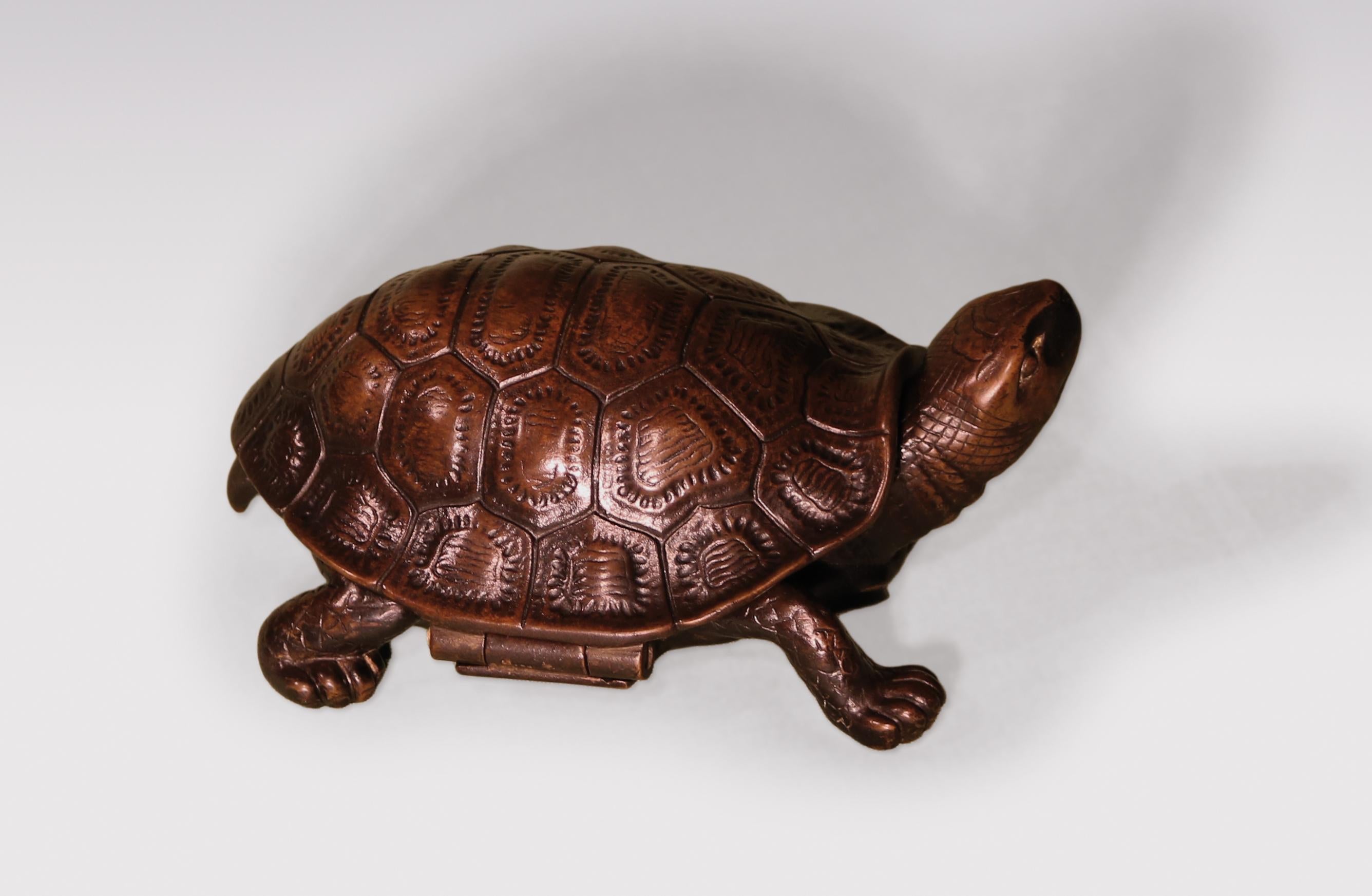 A mid-19th century well-cast bronze model of tortoise, the shell opening to reveal glass inkwell.