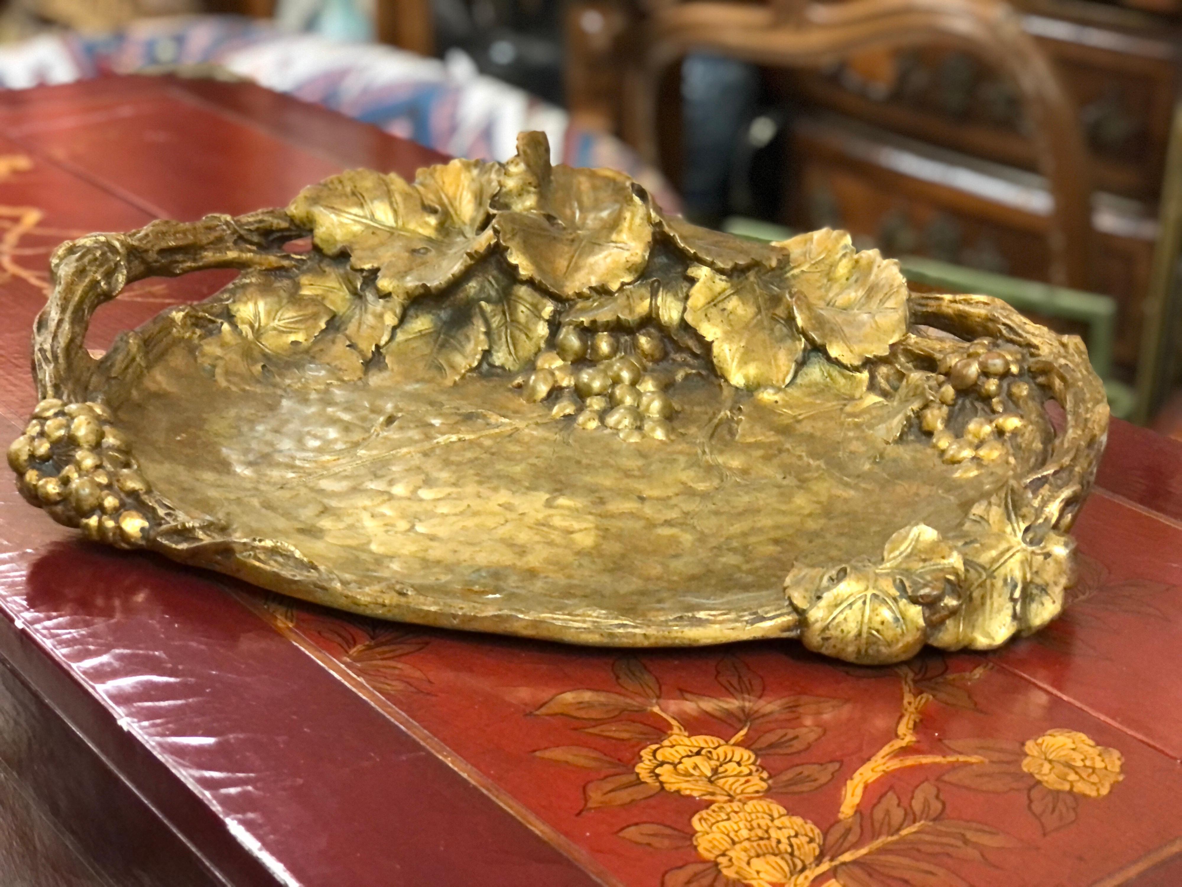 Gilded bronze tray, the border and the grips imitating the wood of the vine branch, beautiful decoration of vine leaves and shearling, hammered bottom.
Signed A. Marionnet 
Measures: 45 x 37 cm.