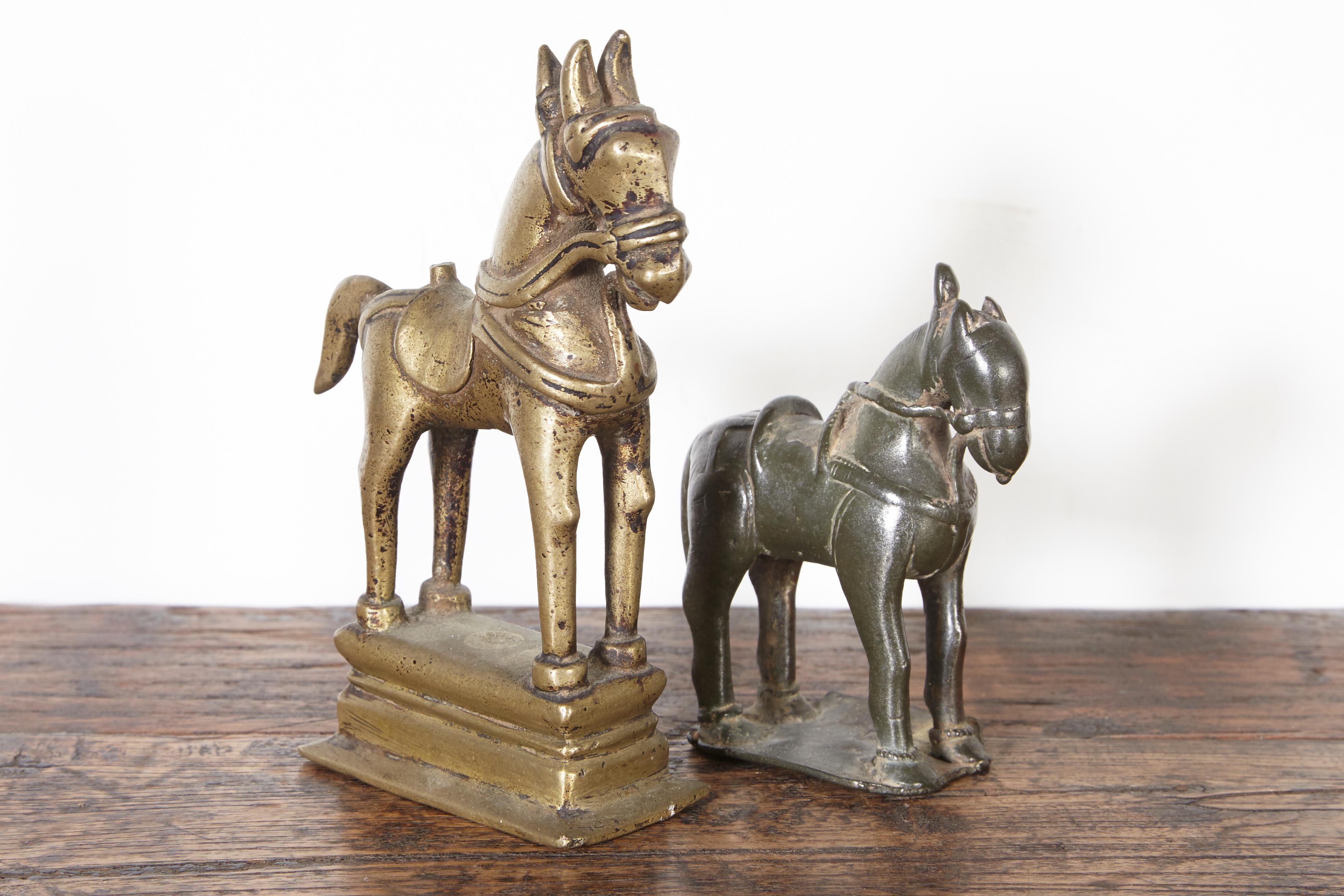 Two nicely cast and beautifully designed votive horses from India, with great patina and presence. These pieces combine spiritually and beauty. 
Priced and sold individually.
Dimensions:
Large: L:3.5 D:2 H:5.5
Small: L:3 D:1.25 H:3.5.
 