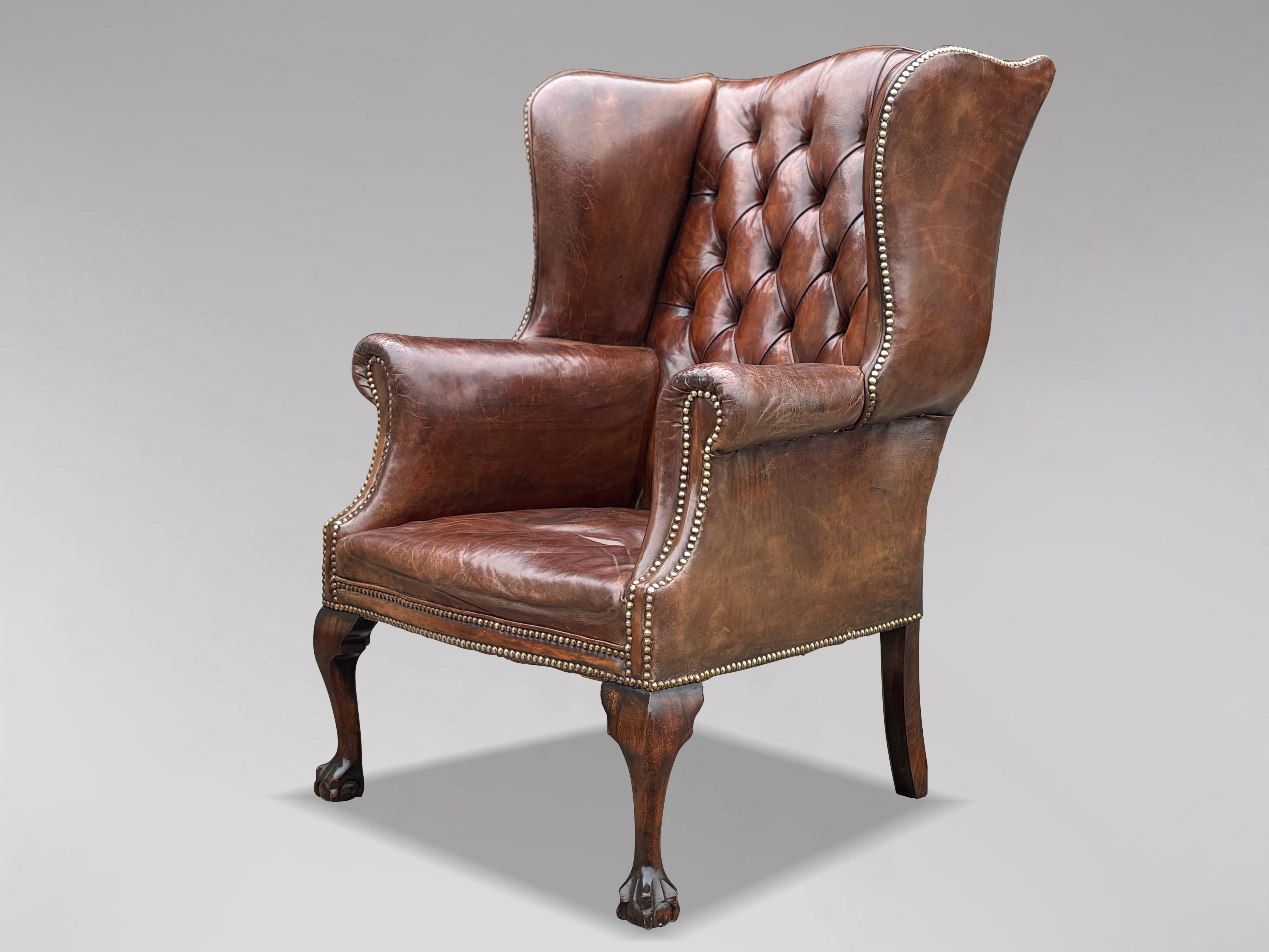This high-quality, untouched 19th-century brown leather button-back wing armchair is designed in the George III style. The substantial, well-shaped frame features a deep-buttoned upholstered back and arms, all covered in the original brown leather.