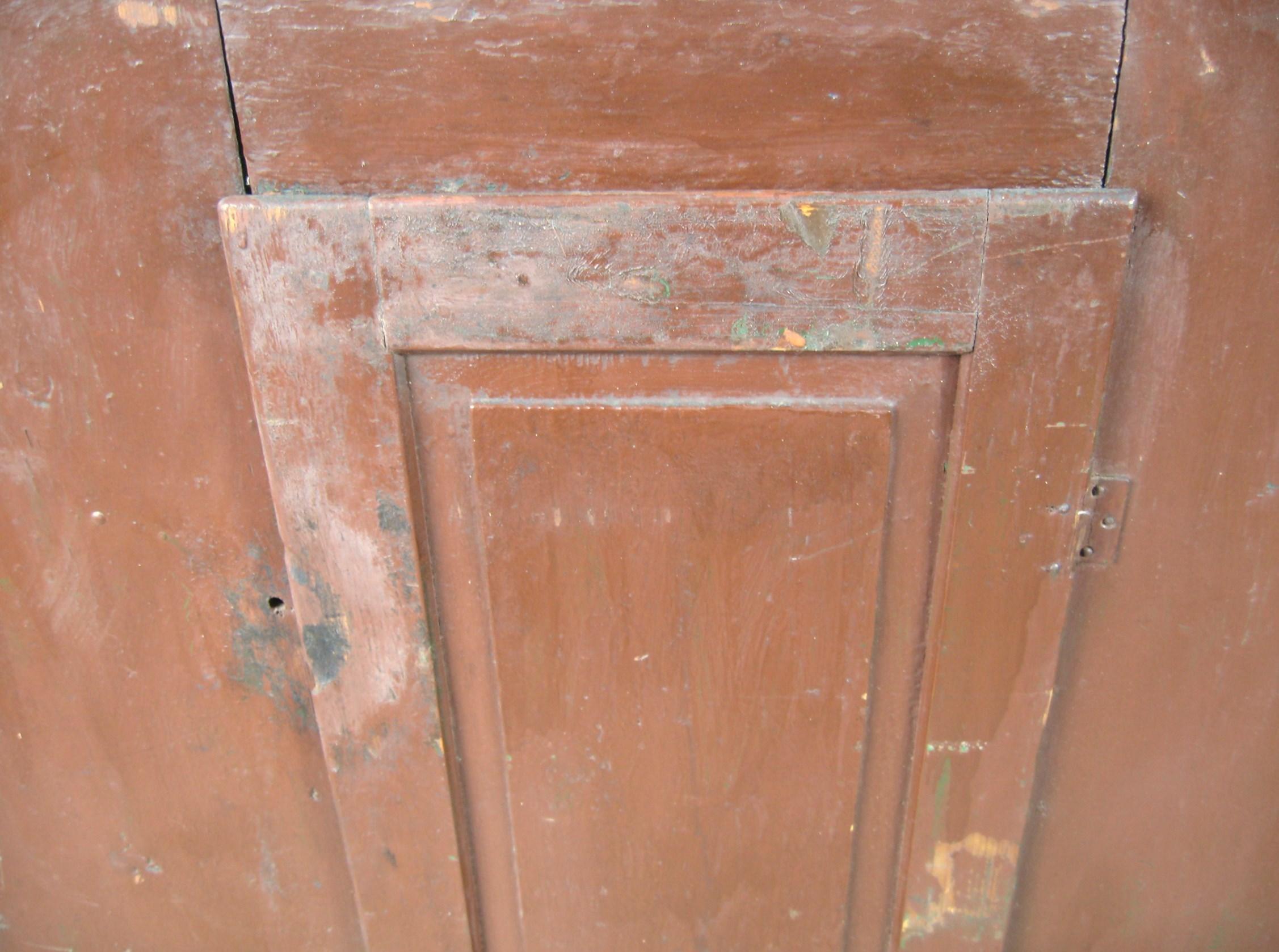 This authentic Fabulous Primitive Blind door painted 1850s Dovetailed cupboard in Brownish / Red, it has many layers of paint which are worn through in many spots to reveal the original color. This is a rare find for collectors and enthusiasts of