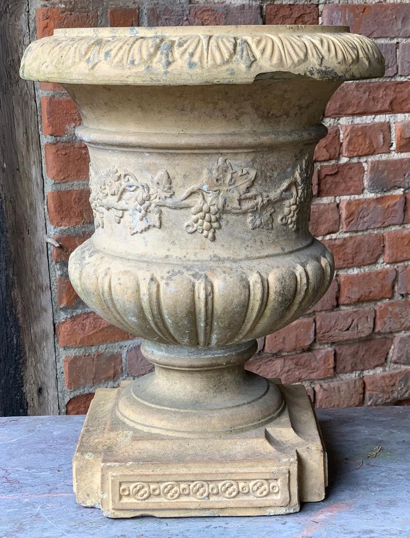 A lovely 19th century buff terracotta urn with grape and vine decoration. Slight losses on rim which you can see in the pictures. Nothing to detract though.