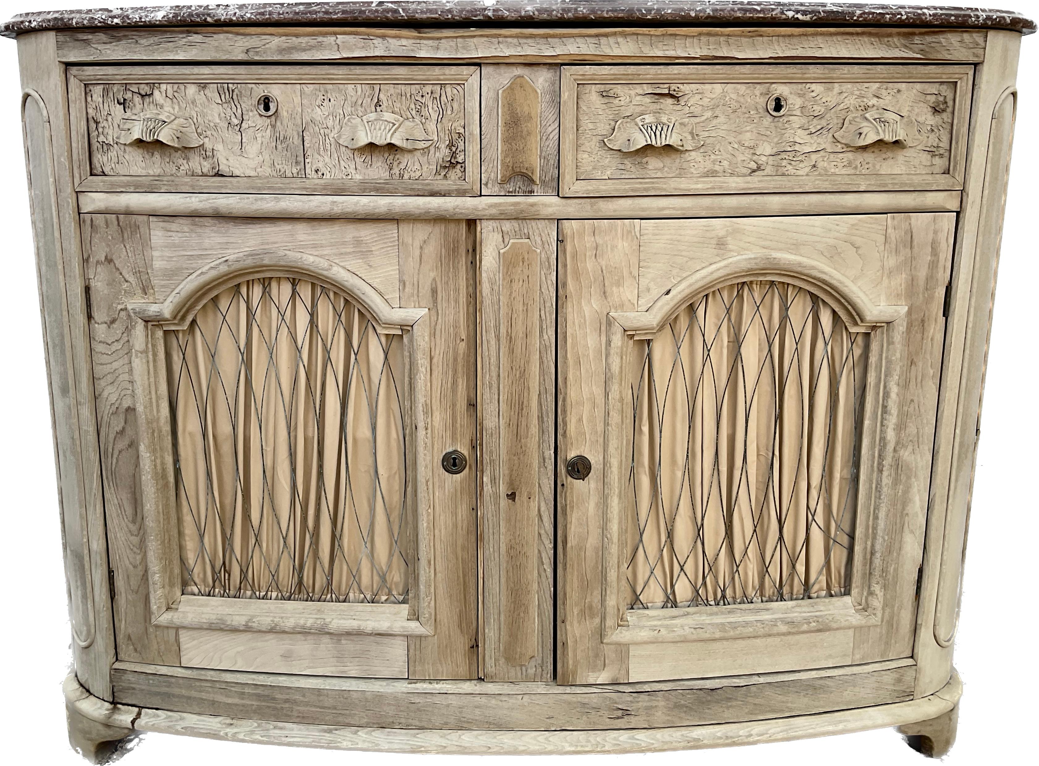 A rather unique late 19th century American buffet / cabinet in a wonderful, bleached finish. With original rouge marble top. Featuring two drawers on top of two cabinet doors with metal screen and fabric adding a wonderful decorative touch. Paneled