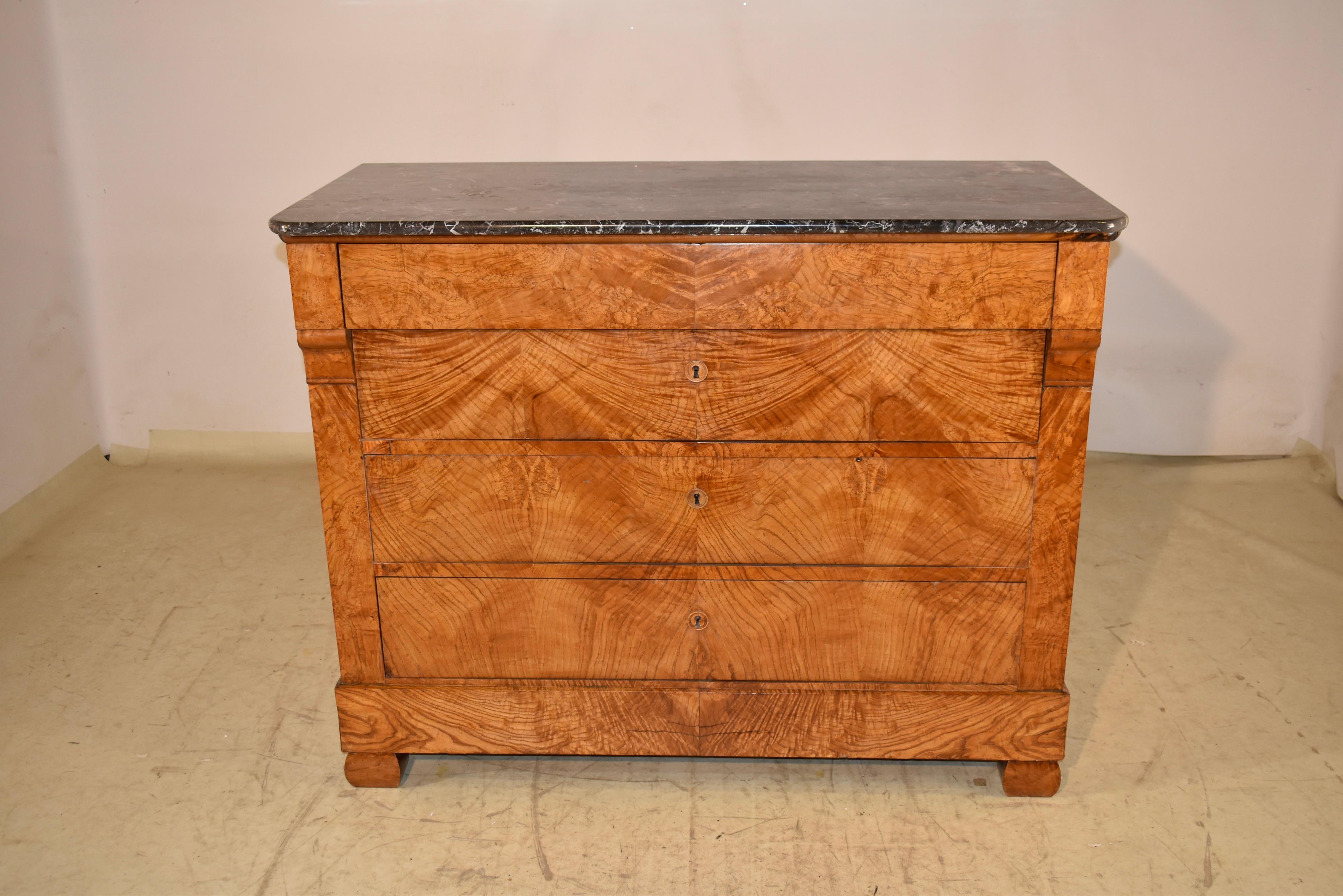 19th century Louis Philippe commode from France.  The top is made from a gorgeous piece of black marble, which has intense graining.  The case of this piece is the real showstopper.  The case is made from stunning Hungarian Burl Ash, and the