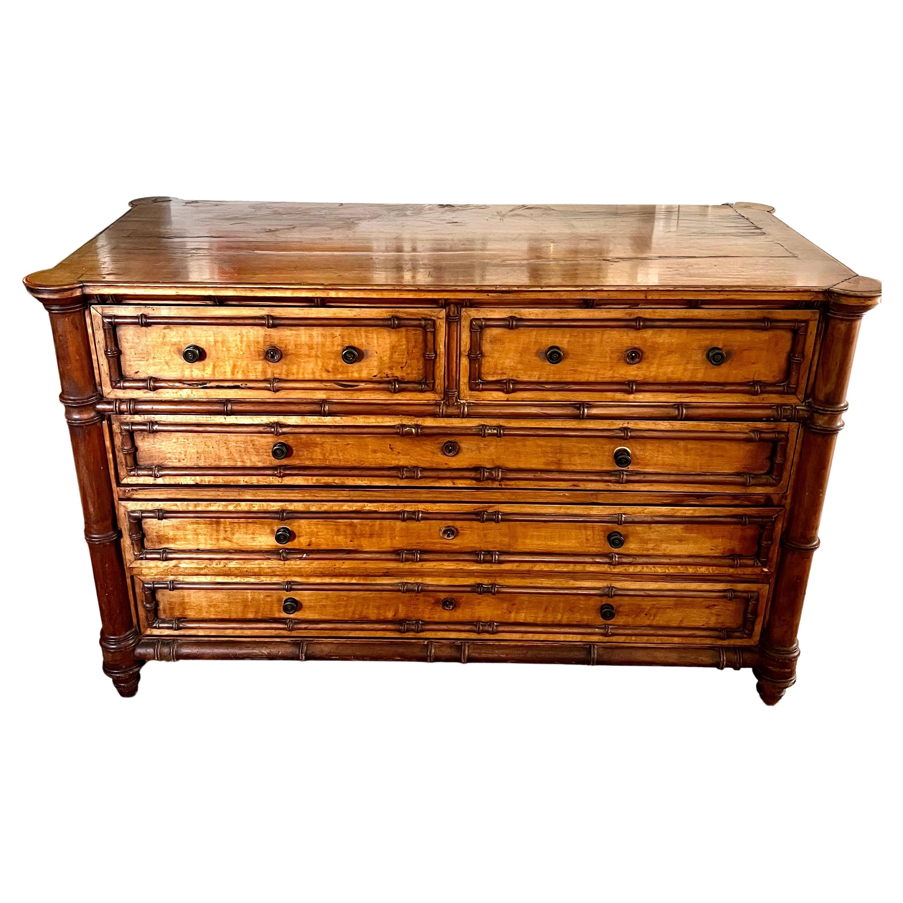A wonderful dresser with 5 drawers, two smaller on the top and three longer ones below. The original key accompanies the piece and works for all of the drawers. 

The color of the wood is wonderful and all of the faux bamboo is in tact and has a