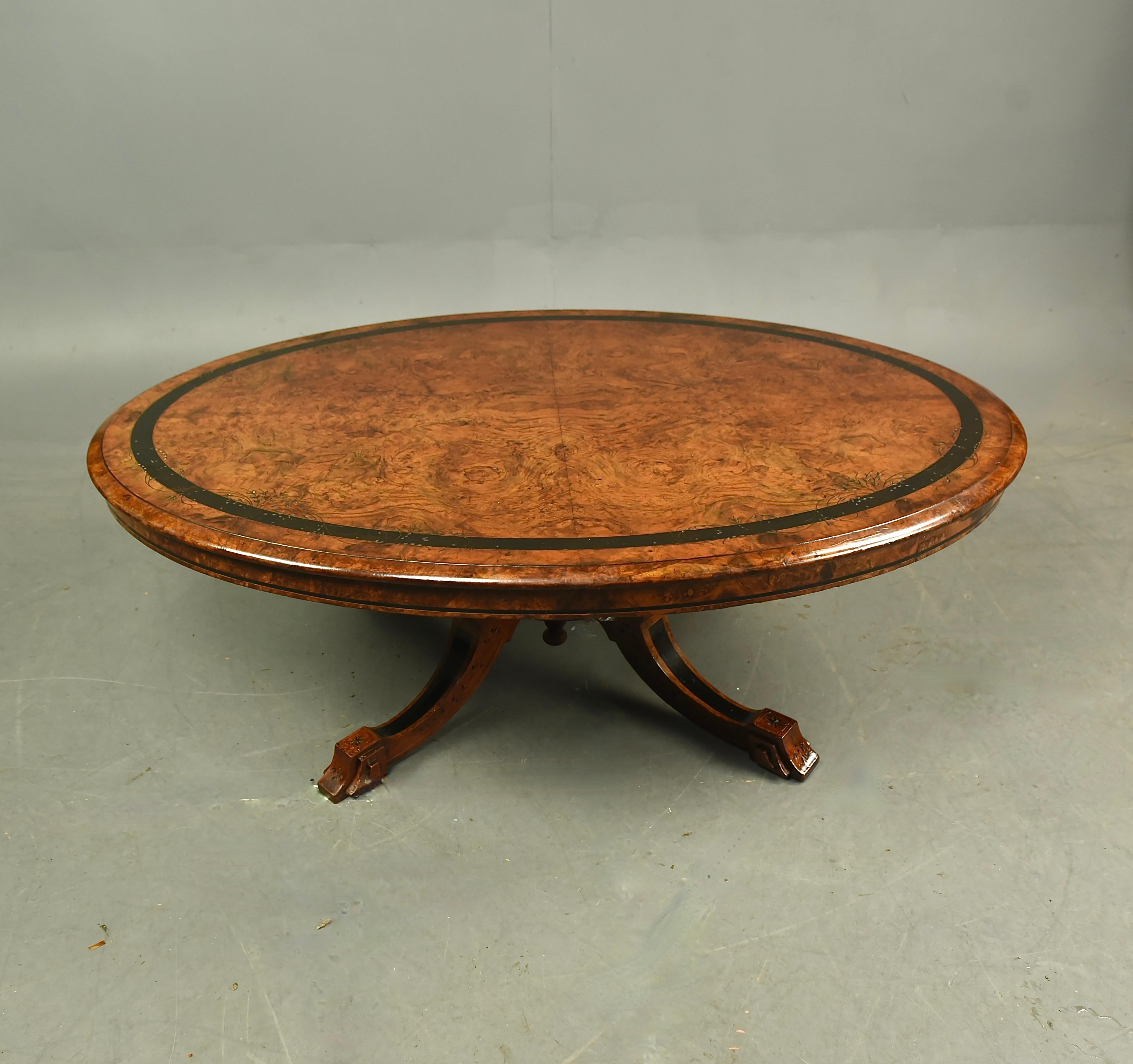 Fine 19th Century Victorian antique oval burr walnut coffee table that is a great colour with good figuring and ebony banding with fine floral carved details. The base has four out swept legs with four fluted column supports.
