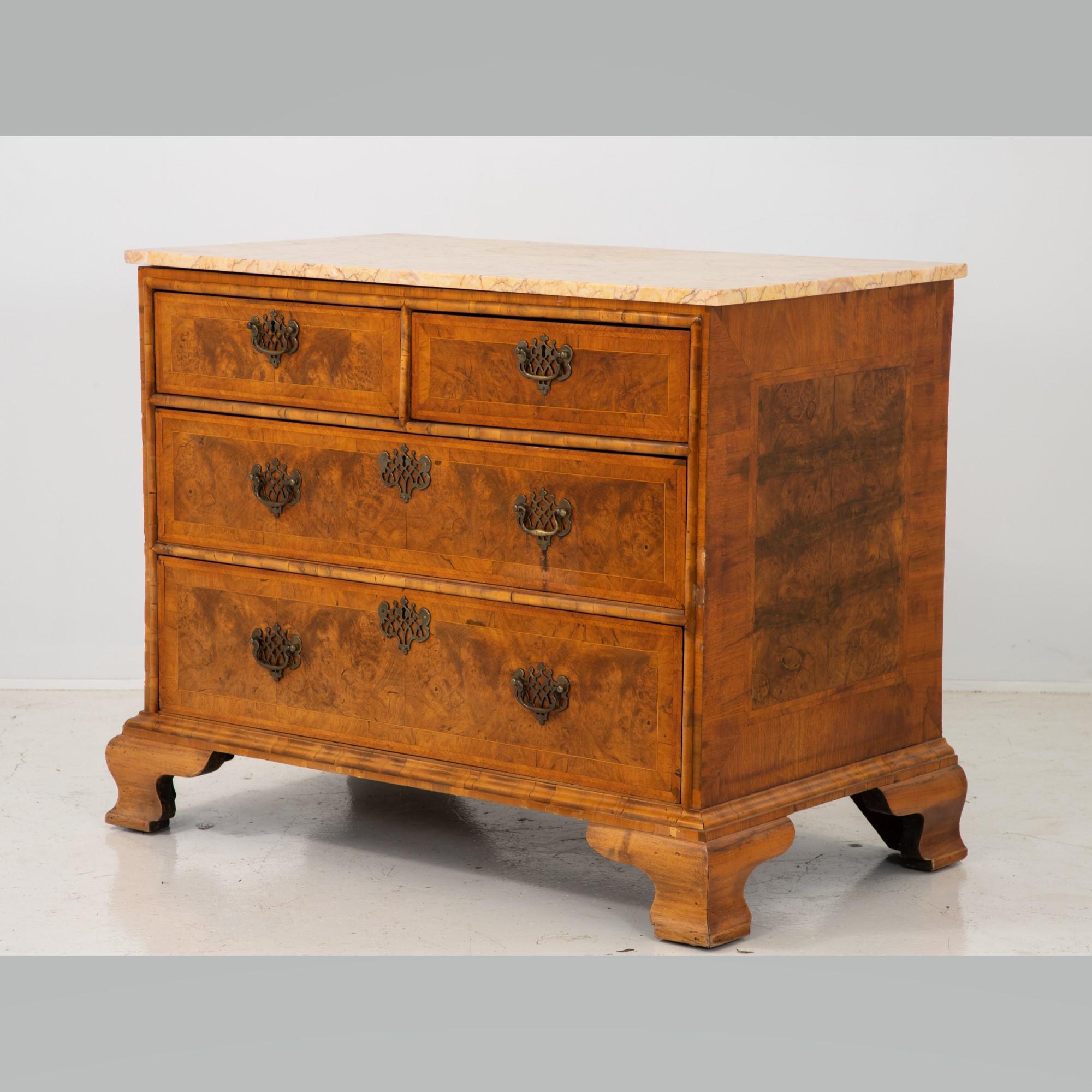 A 19th-century French burl wood chest of drawers with satinwood inlay on drawer fronts and sides with bracket feet. Brass pulls and escutcheons. Original marble top. Wear consistent with age and use.