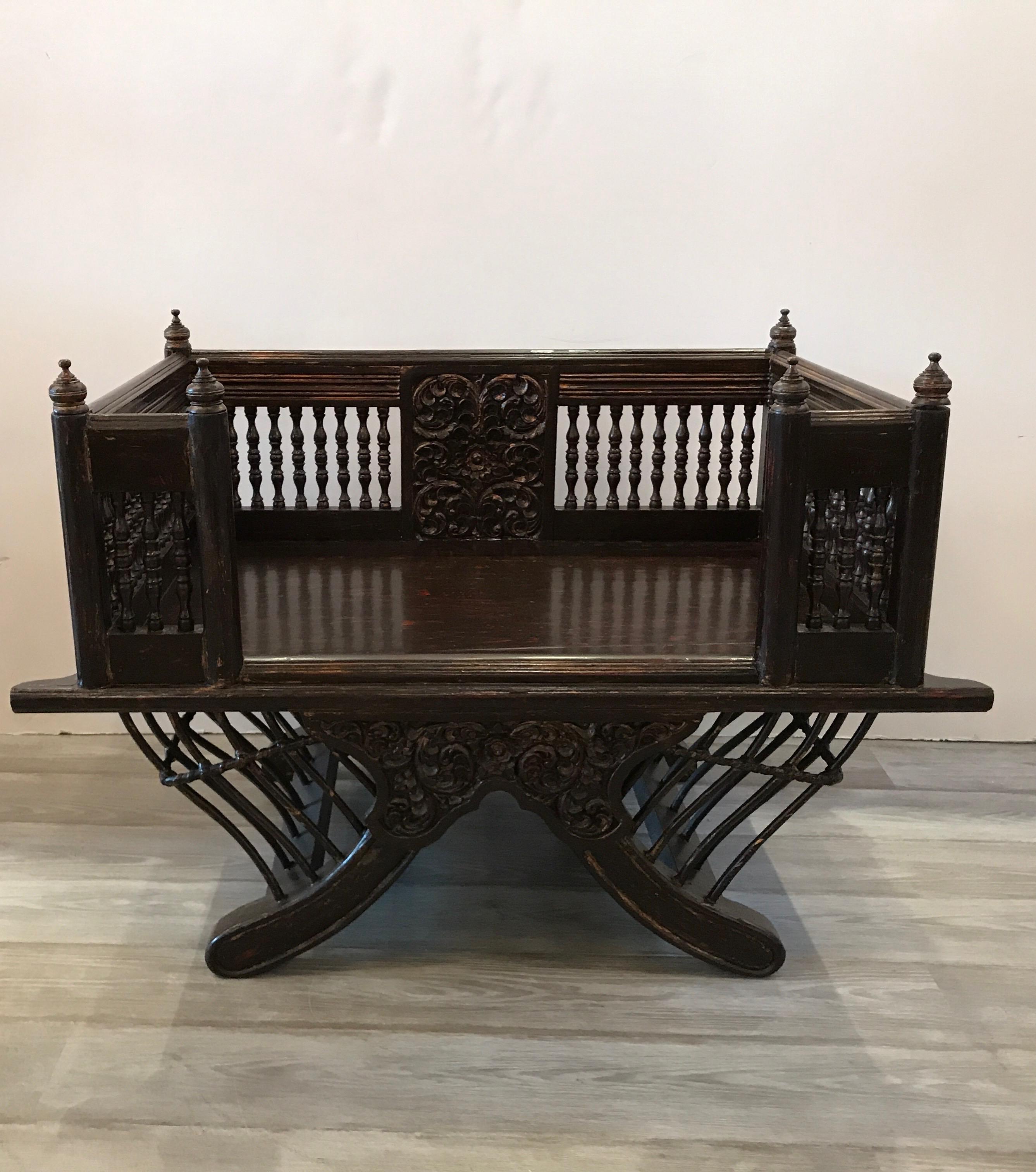 Unusual Howdah elephants seat with hand carvings. This is all original and was used to transport aristocrats and royalty. Light crazing on the finish with a few touch-ups, nothing broken.
