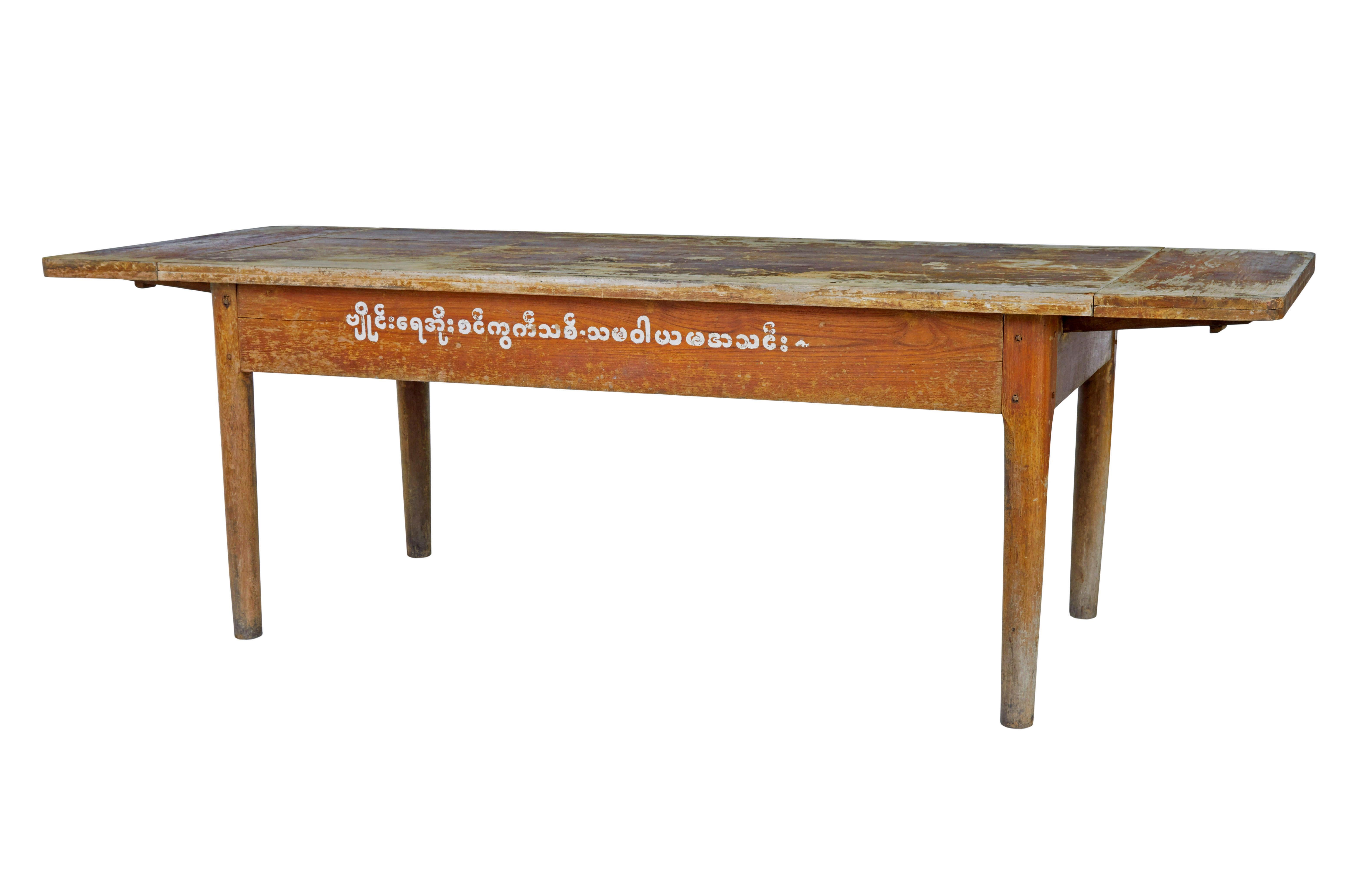 19th century Burmese painted teak village table circa 1890.

Rare table from Myanmar (formerly Burma) .  This table was from a village where the elders would gather round to discuss local issues.  Hand painted on the side, which roughly translates