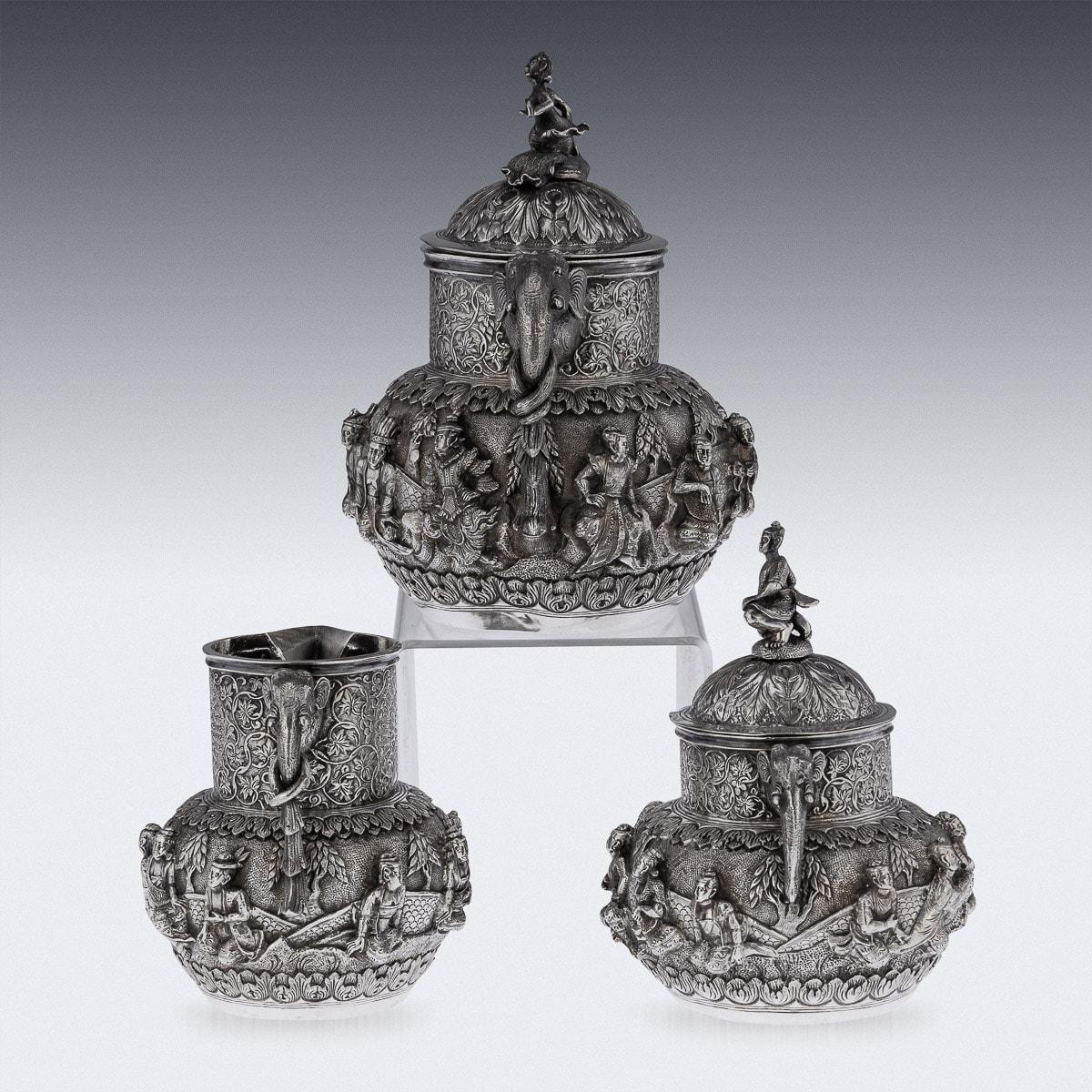 Antique late-19th Century Burmese colonial solid silver three piece tea set, comprising of teapot, lidded sugar bowl, and creram jug, each piece is highly-decorative, chased and repoussed with a continous scene from Burmese mythology, applied with a