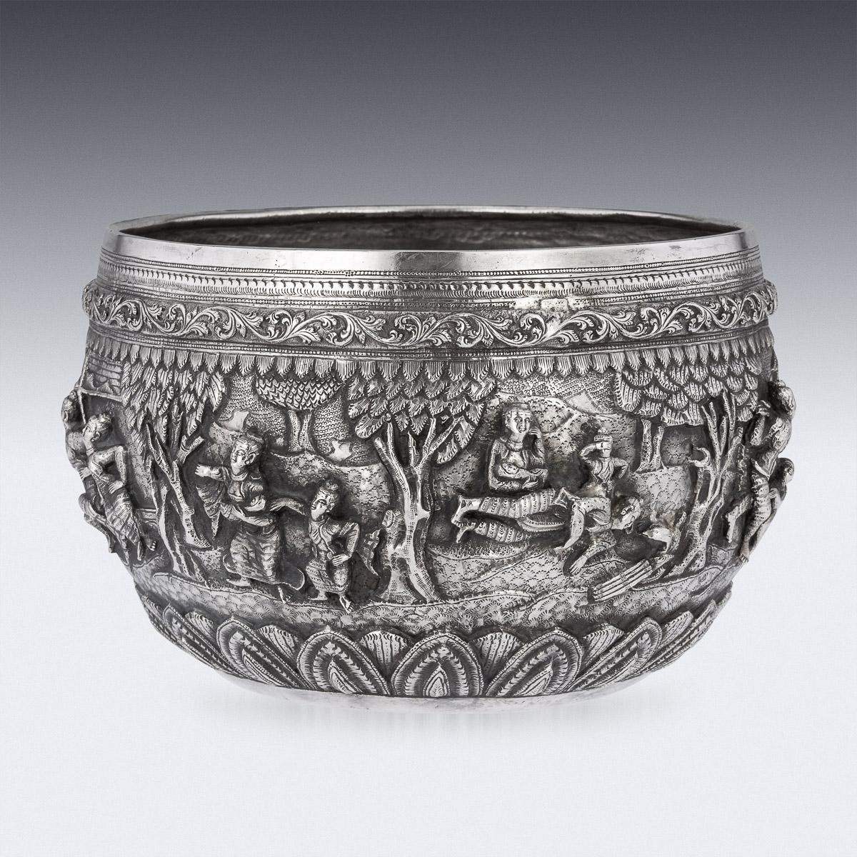19th Century Burmese silver Thabeik bowl, repousse' decorated in high relief depicting different traditional scenes from the Burmese mythology, showing very detailed figures set against a chiseled matted background in landscapes. Around the top