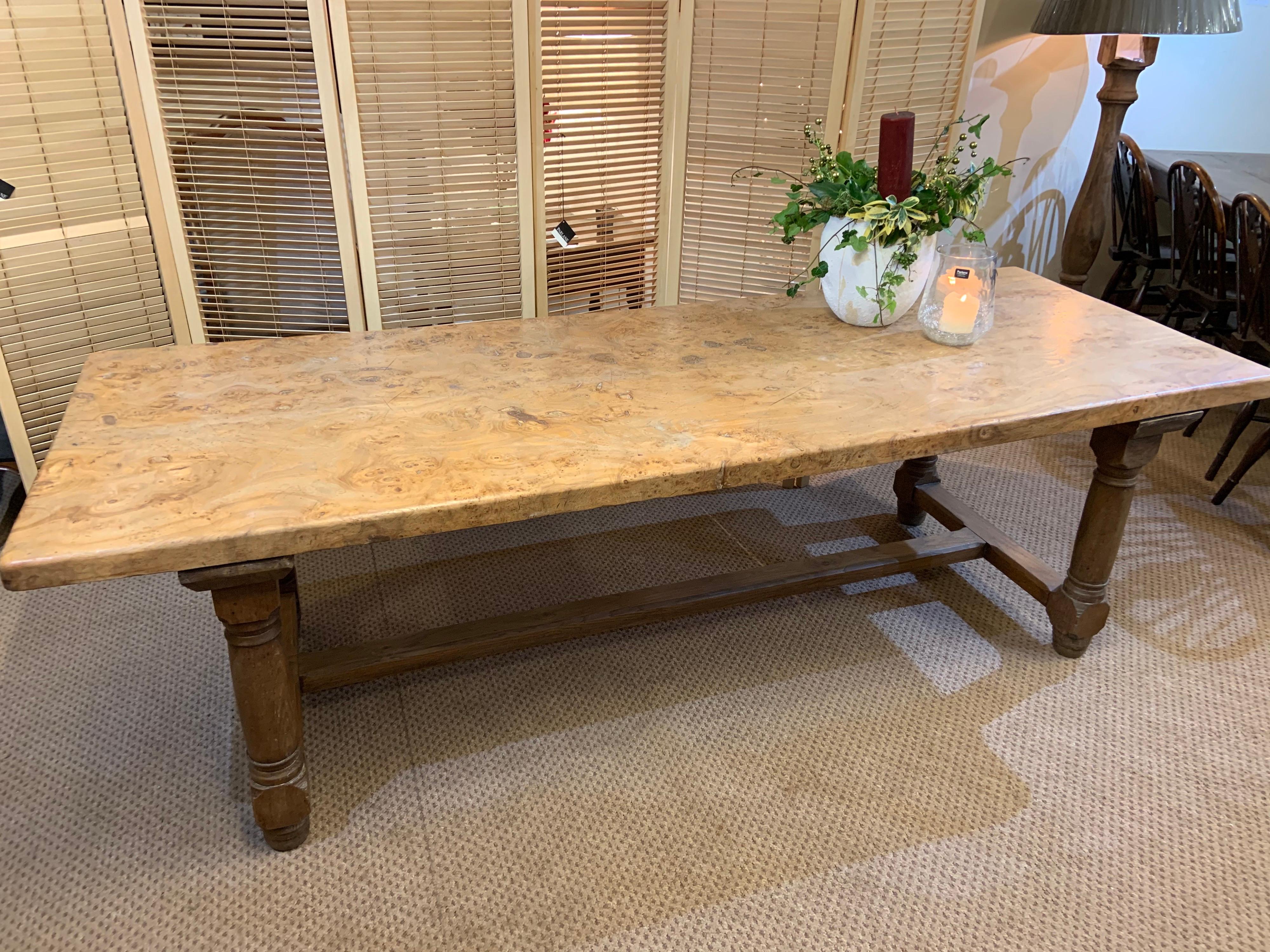 Absolutely stunning figured burr elm antique farmhouse table. The exceptional two plank top sits over four round oak legs united by a centre stretcher. This form of construction allows you to have unhindered leg room.