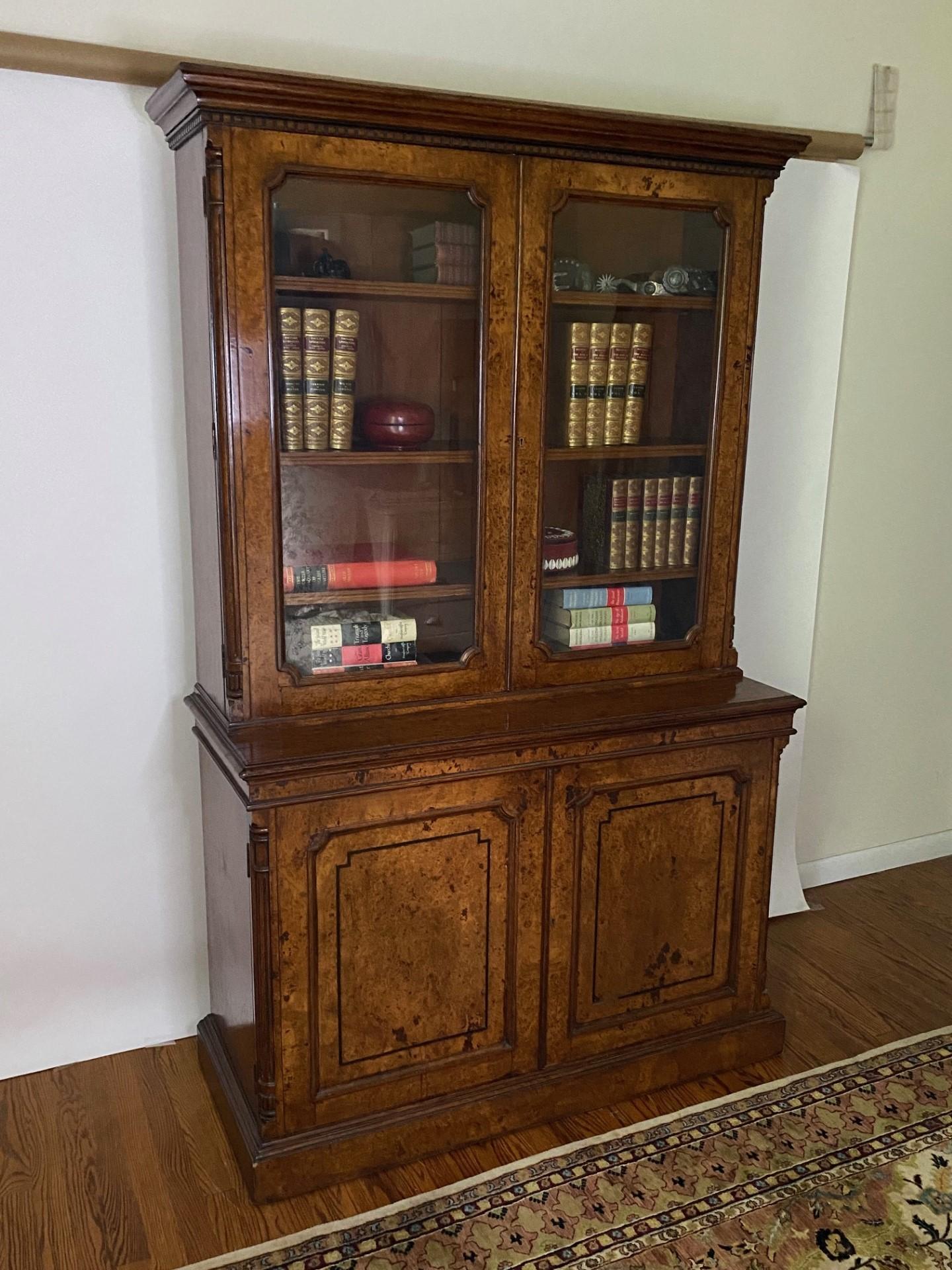 This Fine Antique William IV Burr Oak Bookcase is a piece of furniture from the William IV era, which lasted from 1830 to 1837 in England. This bookcase features both functional and decorative elements characteristic of this period's design