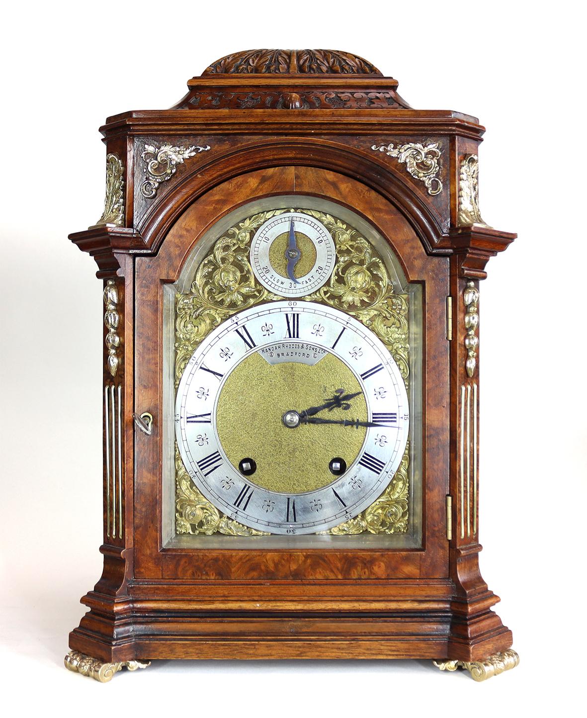 A quarter striking bracket clock in a fine figured burr walnut case with ormolu mounts and sound frets backed in sage green silk. A gilded dial with silvered chapter ring, roman numerals and gothic steel hands. 

With rise fall regulation at the top