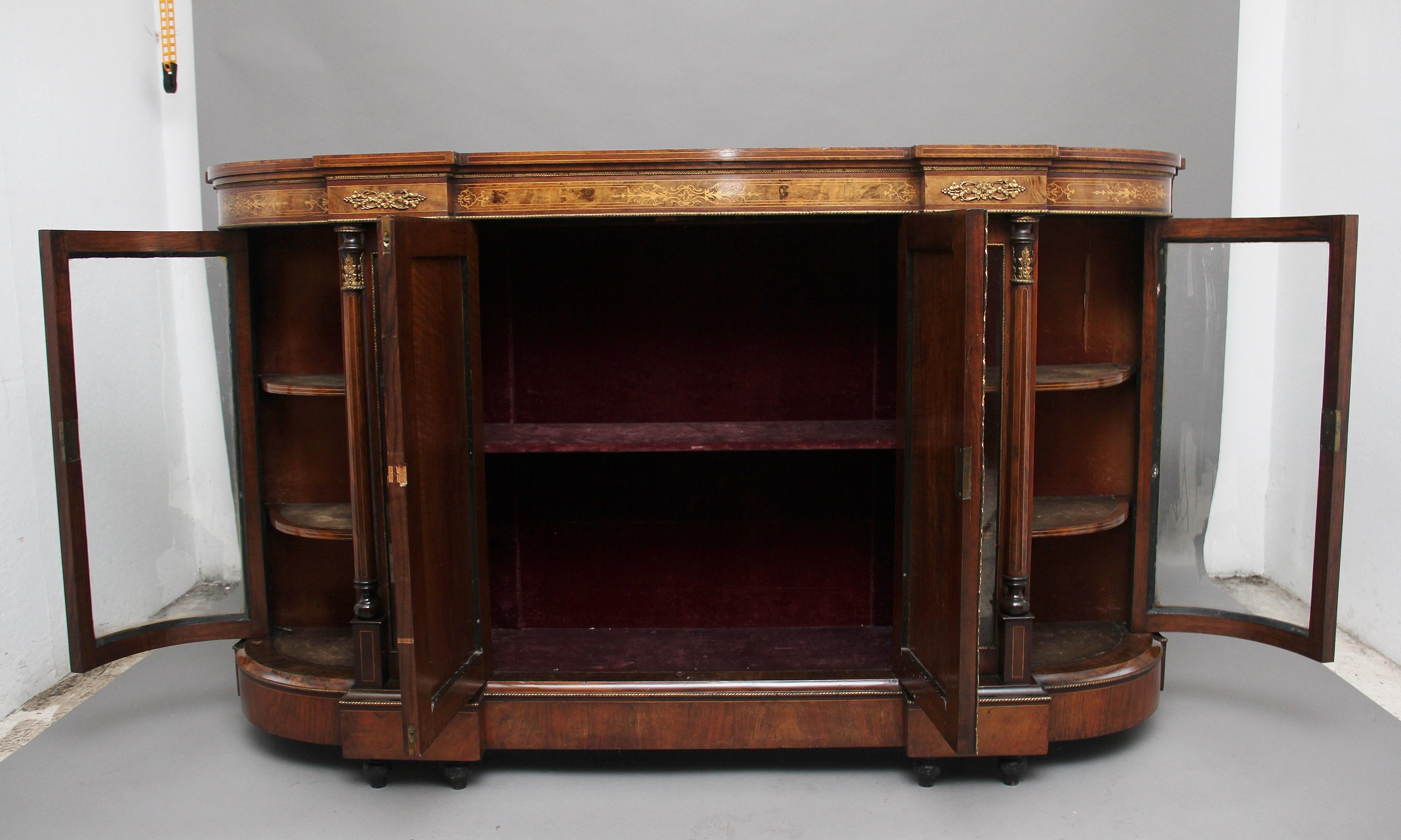 A fabulous quality 19th century burr walnut and inlaid breakfront credenza, the shaped, crossbanded and wonderfully figured top above an inlaid frieze decorated with ormolu beading and mounts, with two cupboard doors at the centre which have