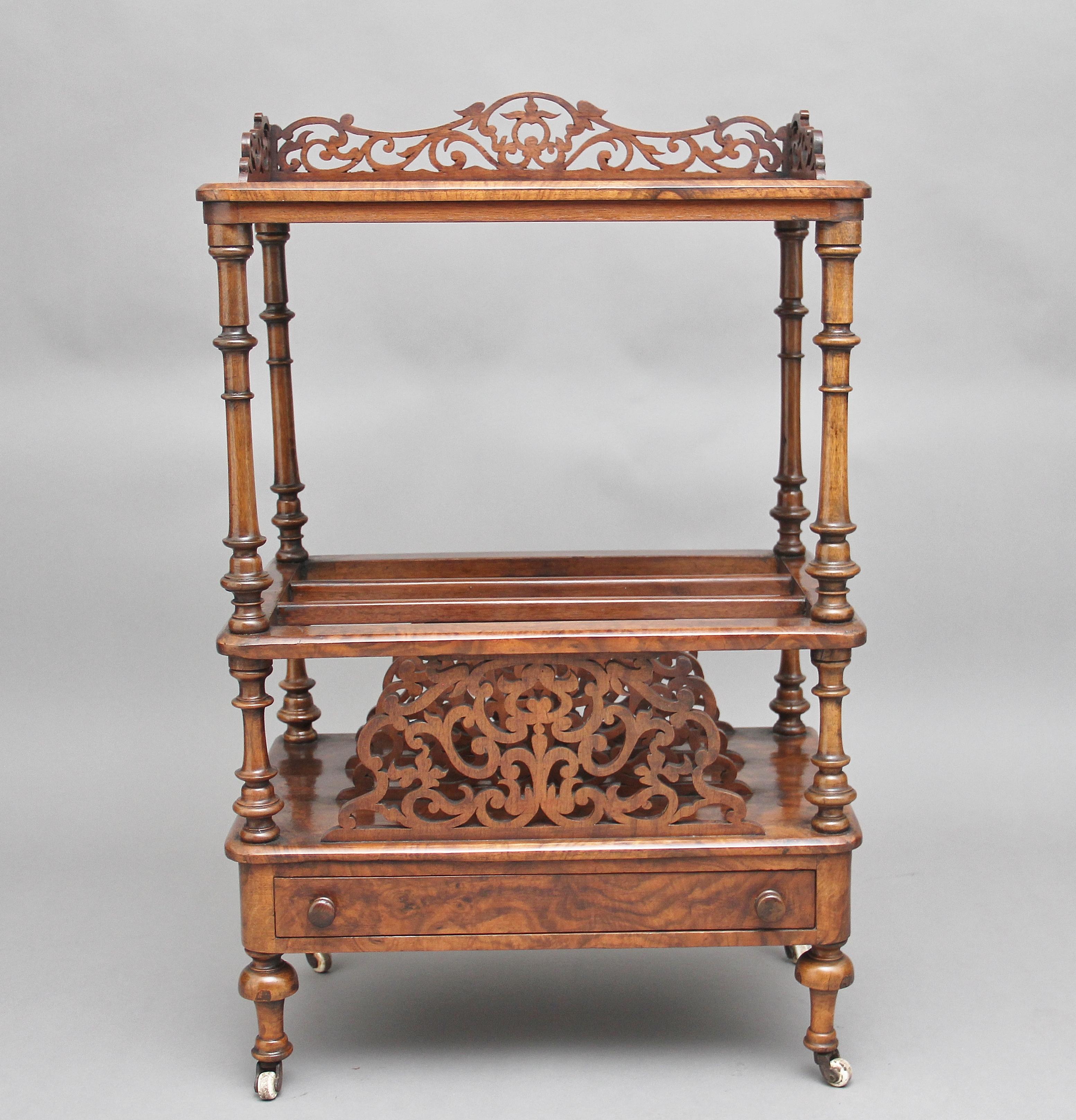 19th century burr walnut canterbury, the burr walnut top having a pierced and carved gallery, supported on finely turned columns, the middle section having three divisions which is divided by finely carved and pierced splats, having a single drawer