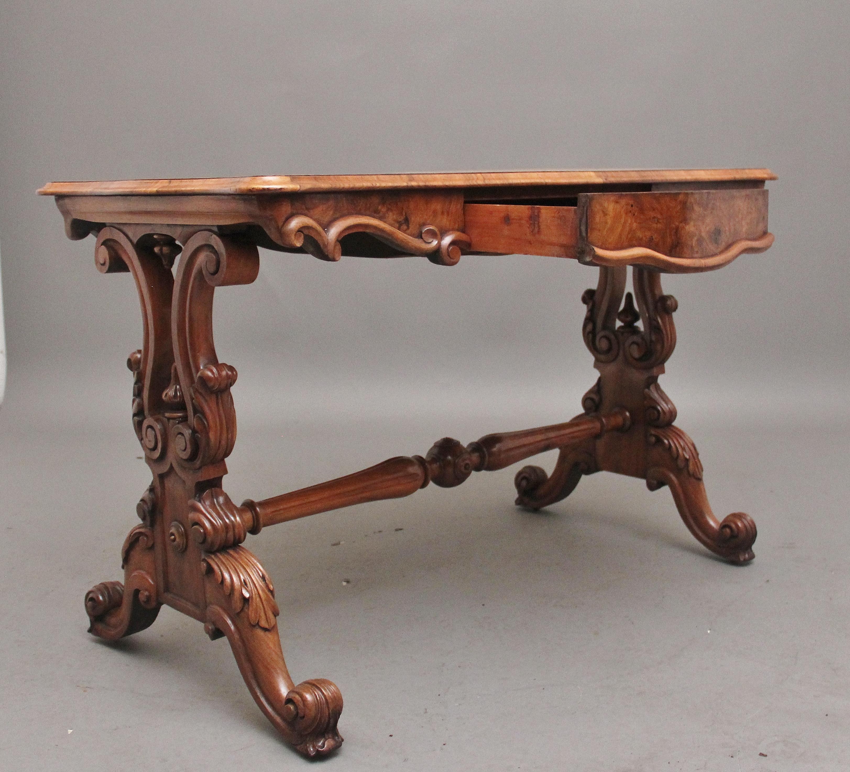 19th Century burr walnut centre / occasional table, the wonderfully figured shaped and moulded edge top having a single frieze drawer below, with stylised mouldings along the bottom edge, supported on wonderfully carved and shaped end supports with