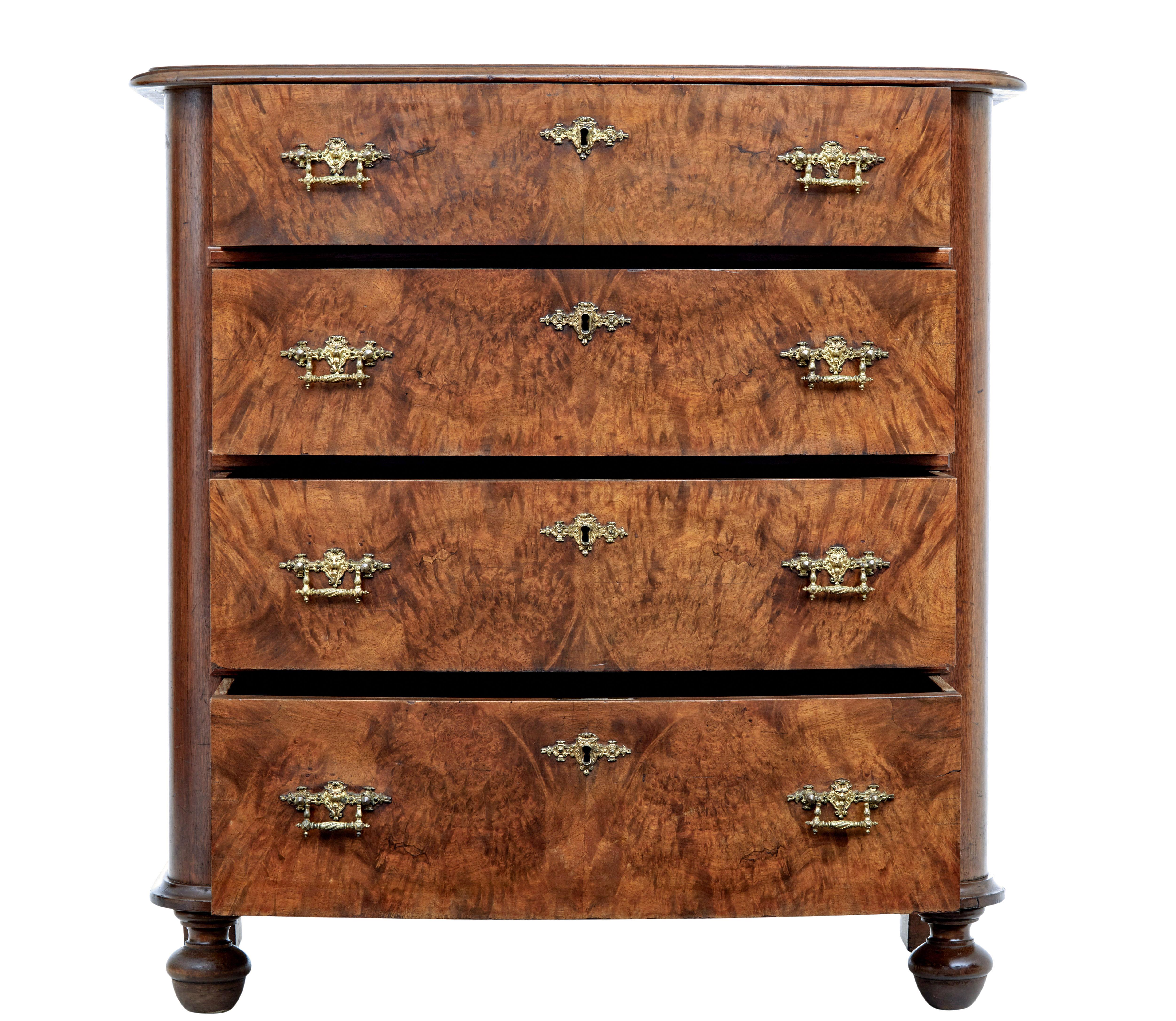 19th century burr walnut chest of drawers circa 1880.

Good quality slight bowfront chest of drawers, fitted with 4 drawers veneered in burr walnut.  Each drawer fitted with a pair of ornate lion's head cast brass handles and escutheon plate. 