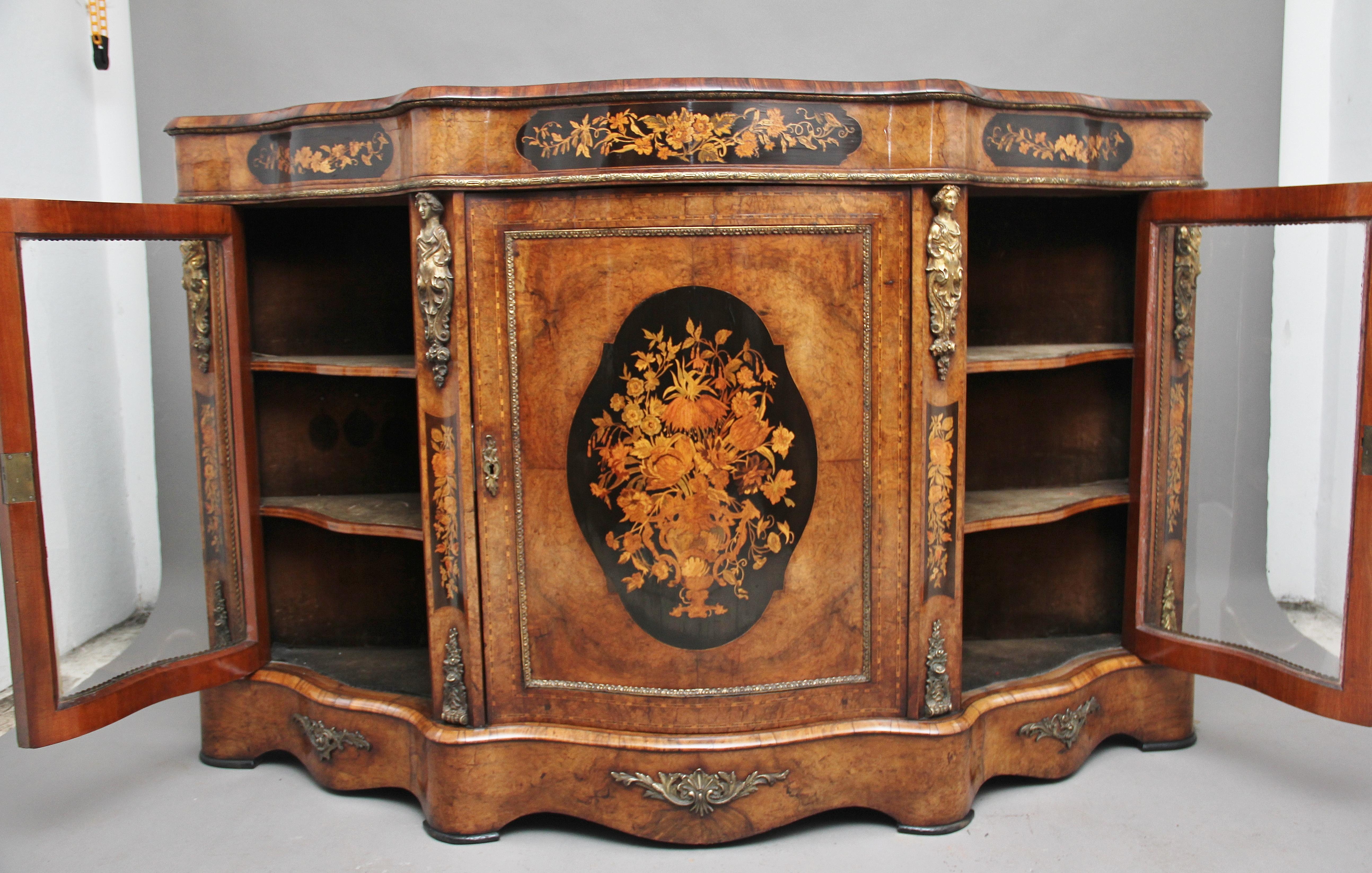 A superb quality 19th century burr walnut and floral marquetry credenza of serpentine form, having a beautifully shaped and figured burr walnut top above a frieze with ormolu moulding, decorated with floral inlaid marquetry panels, the central