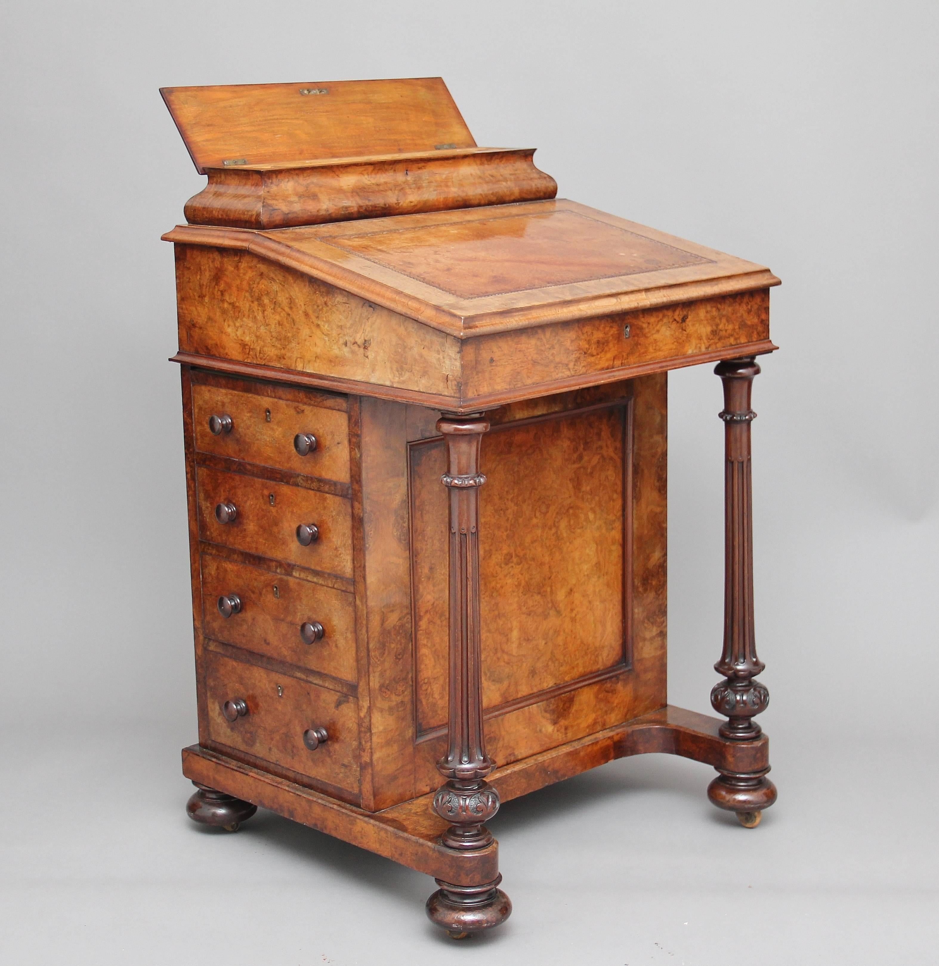 19th century burr walnut davenport, the sloping top has a nice parchment colour leather writing surface decorated with blind tooling, which lifts up to reveal a compartment with four drawers, two of which are dummy drawers, there is a superstructure