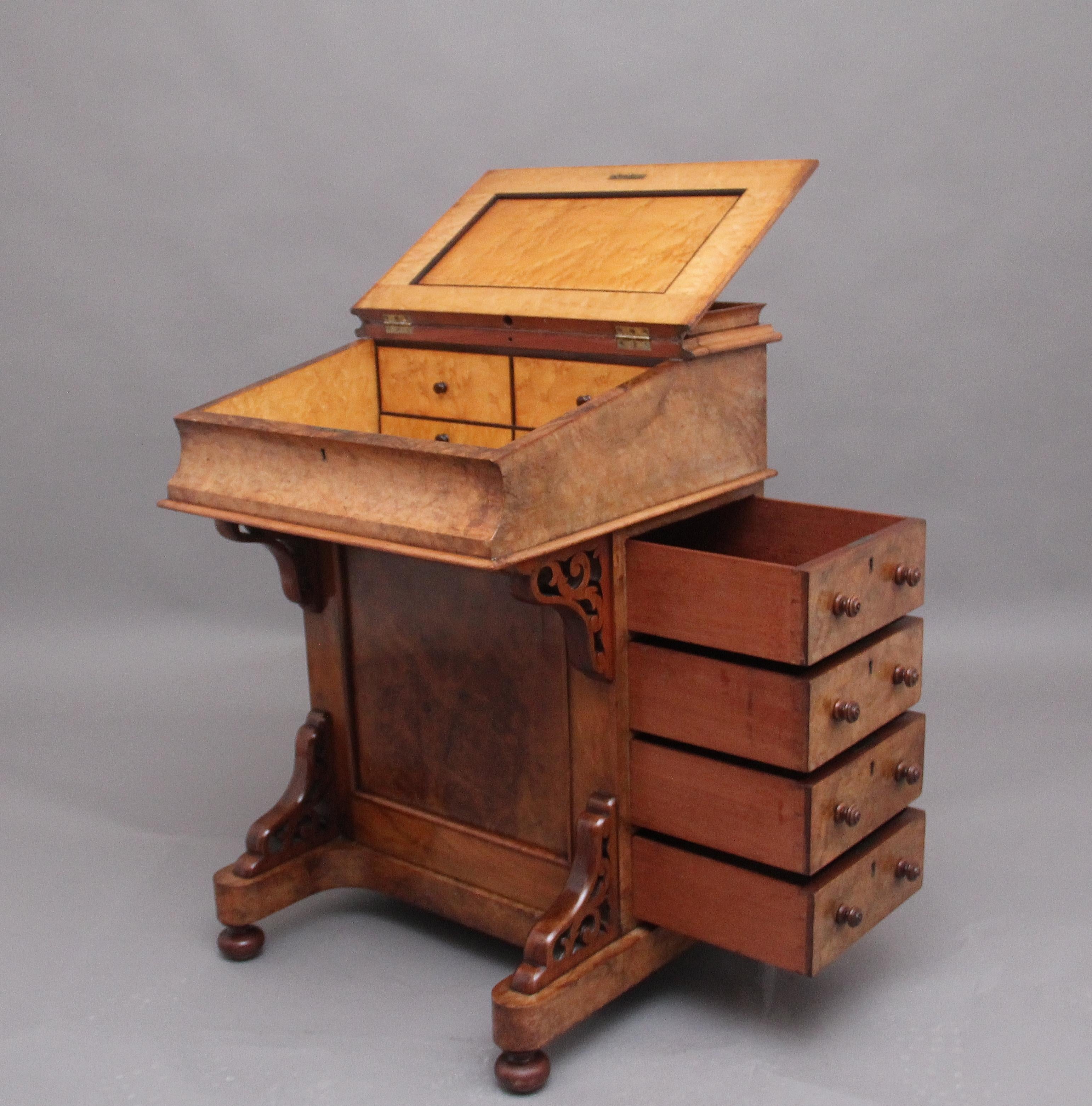 19th century burr walnut davenport, the sloping top has the original tan colour leather writing surface decorated with blind tooling, which lifts up to reveal a compartment with four drawers, two of which are dummy drawers, also on top there is a