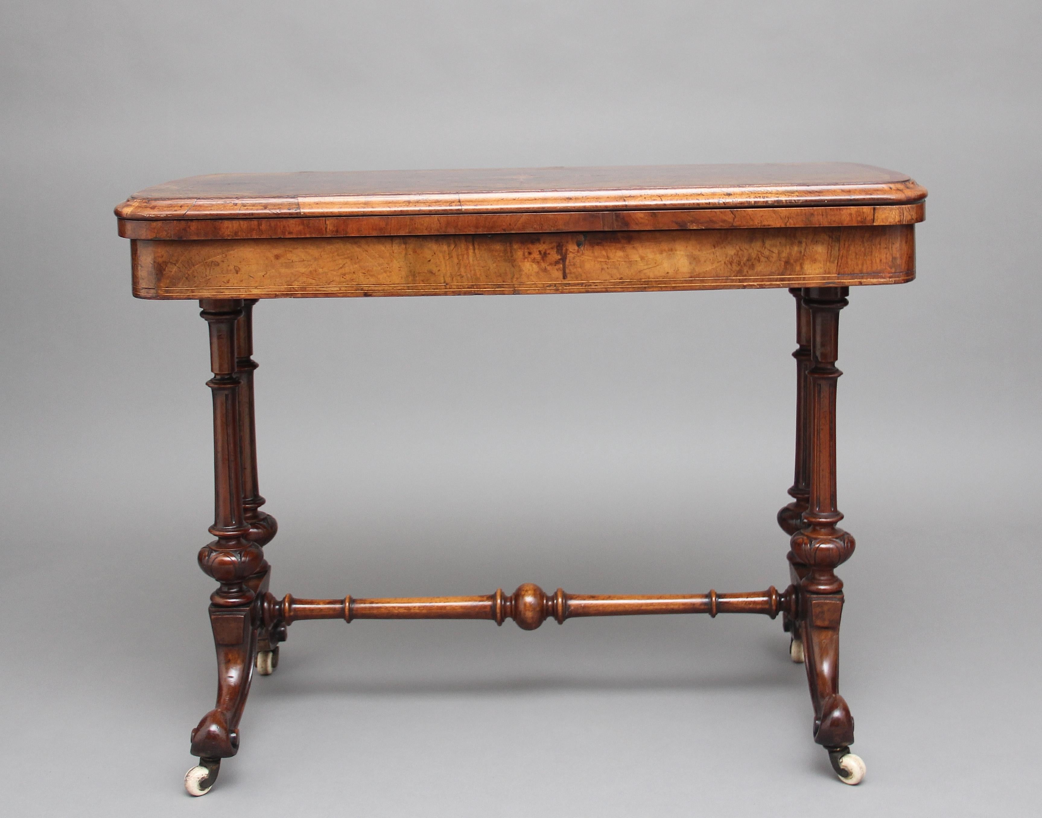 19th century burr walnut and marquetry card table, the rounded rectangular top crossbanded in amboyna, boxwood inlay, and a nice marquetry pattern at the centre, the folding top which open out to reveal a green baize lined playing surface, supported