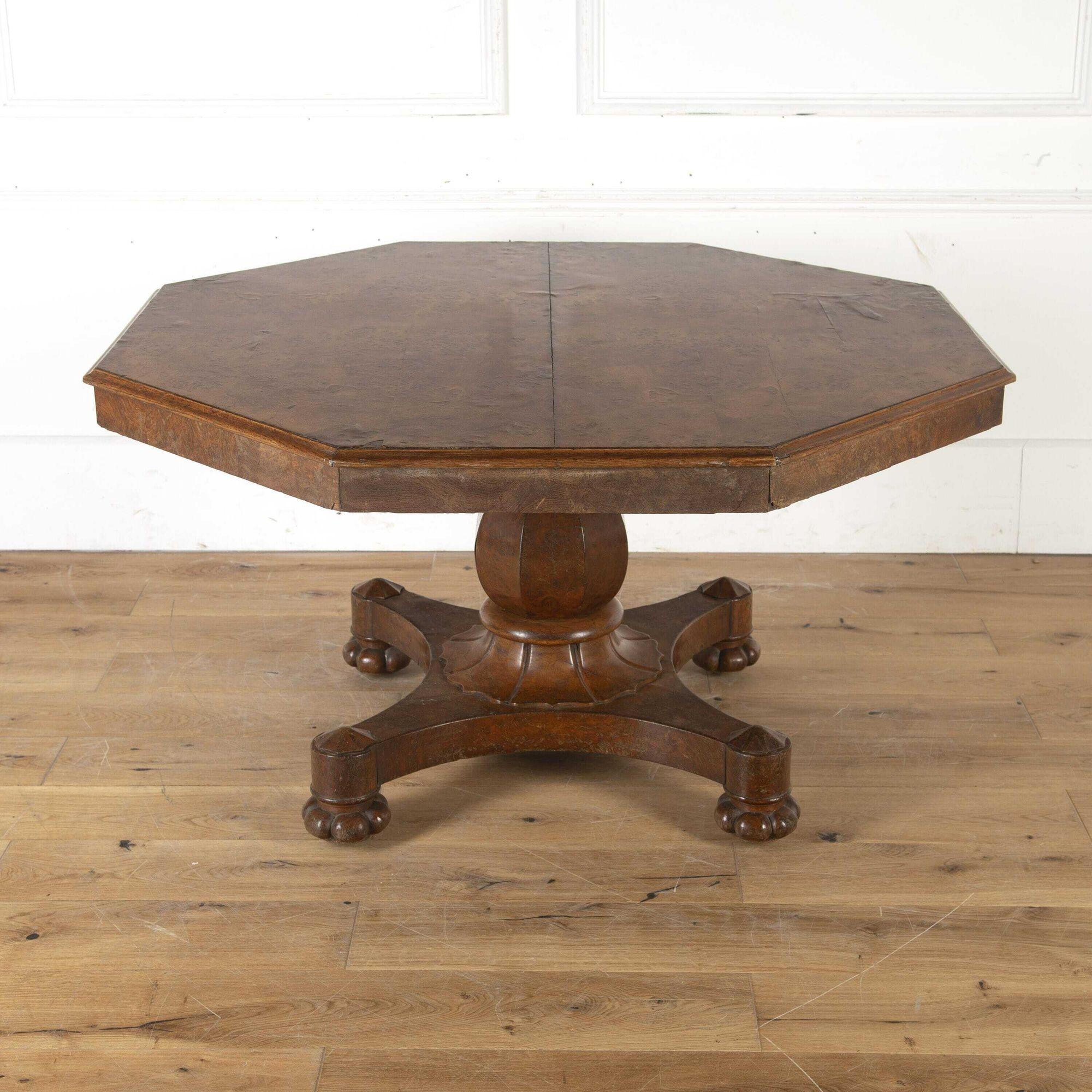 English 19th Century burr walnut centre table. 
The beautifully figured octagonal top is supported on a balustered central support column with a gadrooned base. 
Resting on a shaped quadriform base with four carved bun feet. 
This is a classic