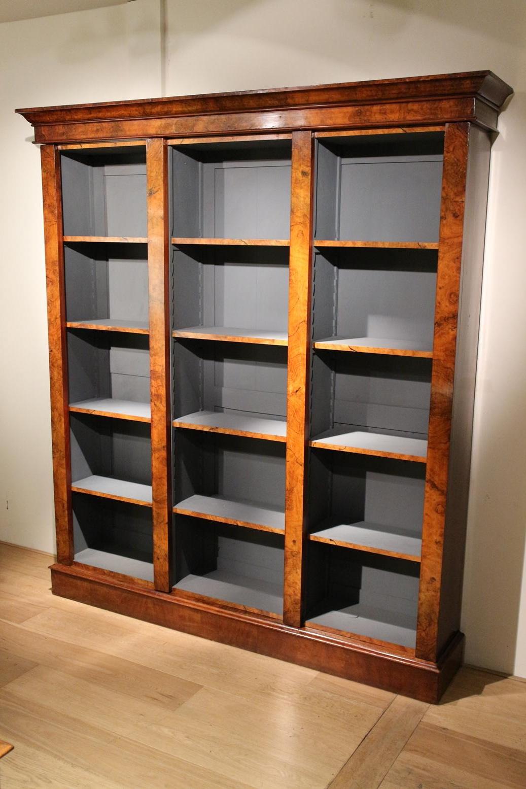 Beautiful antique open bookcase, the inside of which is finished in blue. Shelves are adjustable. the burr walnut has a beautiful pattern and color. Details such as the front of the shelves, make it a beautiful piece. Cabinet consists of 4