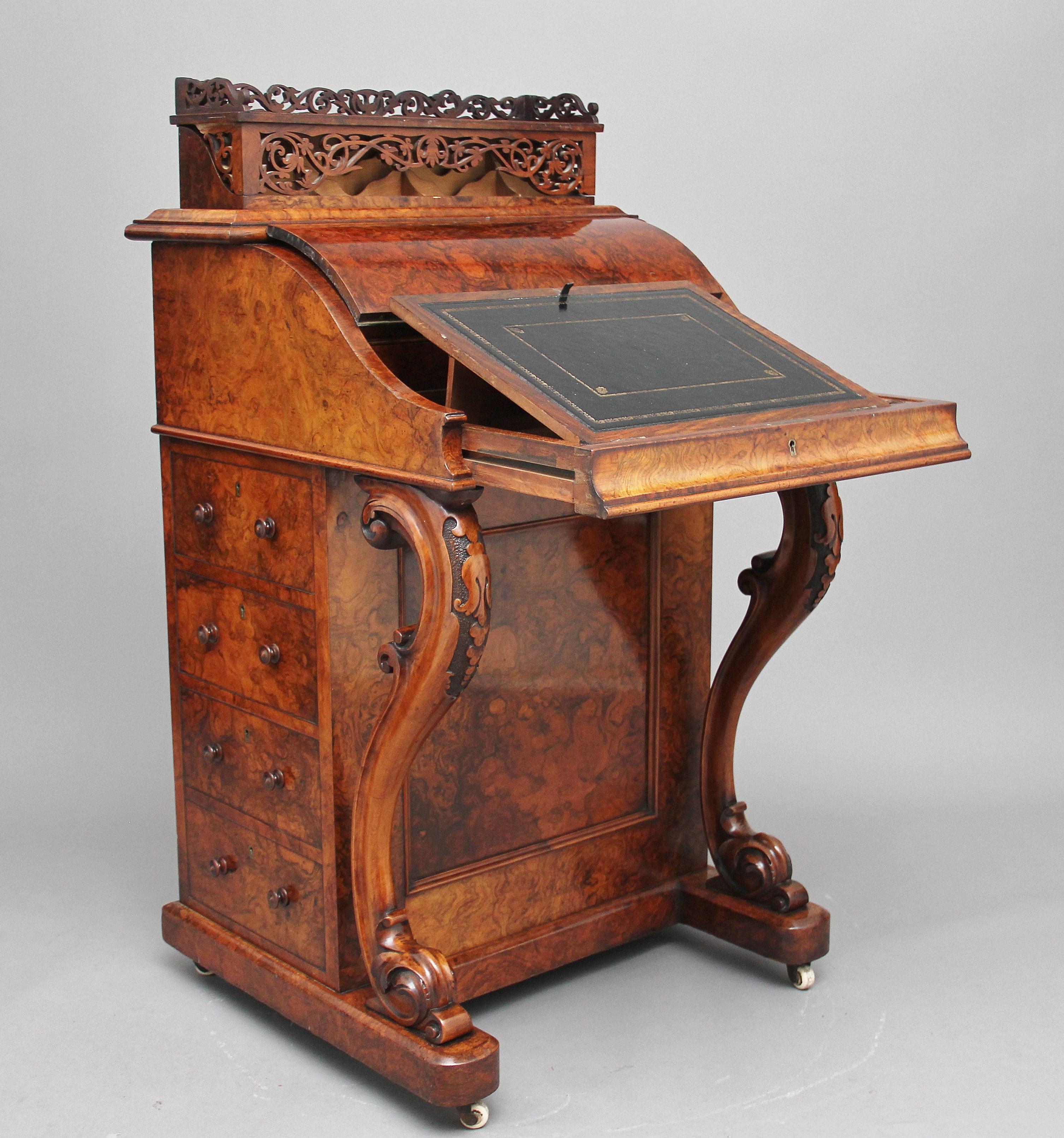 A superb quality 19th century freestanding burr walnut rising top davenport, the moulded edge top decorated with carved fretwork, this section rises up from the desk which shows more intricate carved fret work which lifts over to reveal various