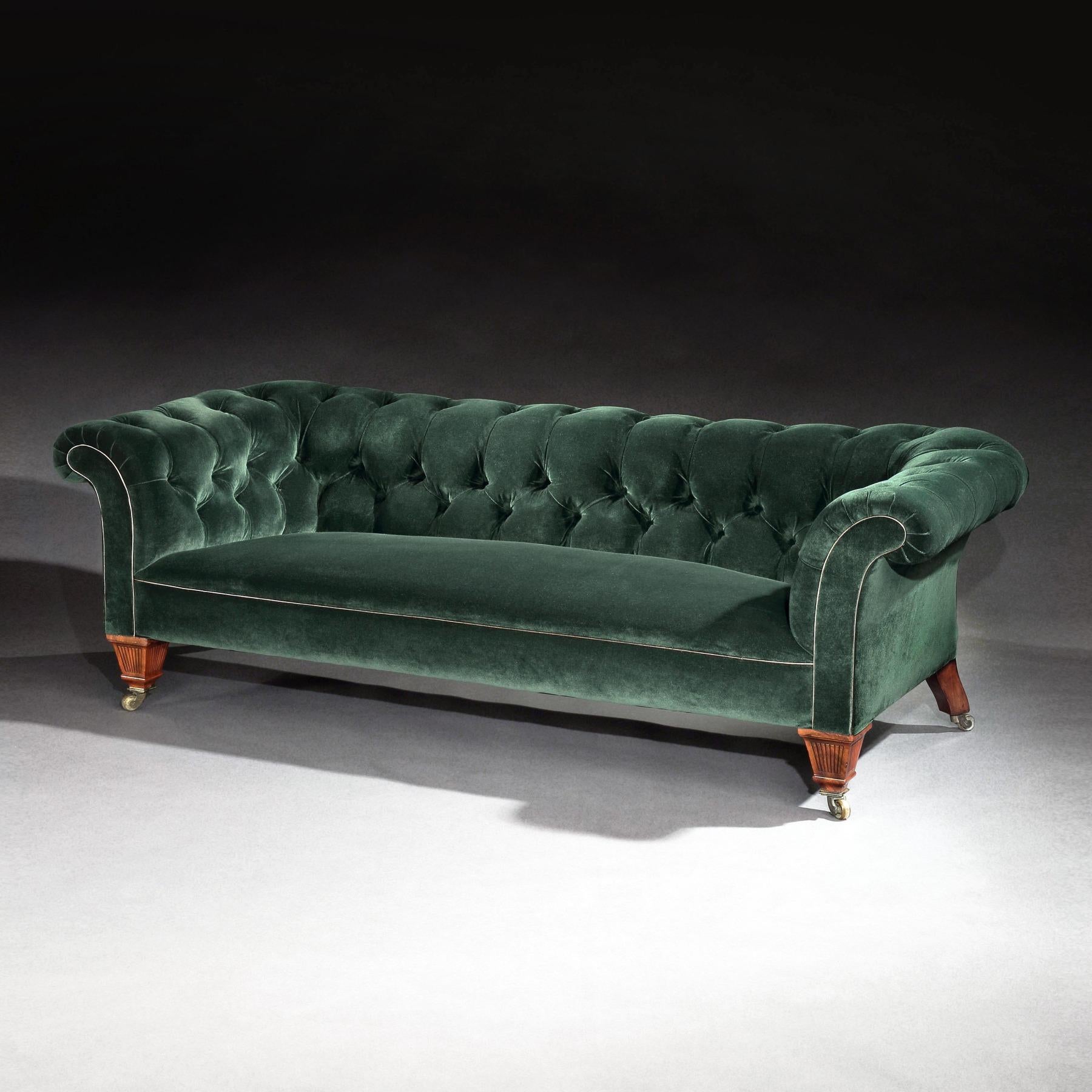 Well proportioned 19th century Victorian Chesterfield sofa having unusual reeded tapering front mahogany legs on the original gilt collars and stamped castors C Hindley and Sons, London.

English, London made circa 1870.

Having out scrolled