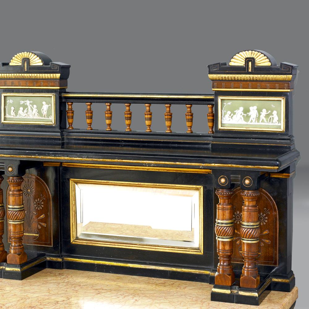 An Exhibition quality cabinet by LAMB of Manchester.

An ebonised mahogany, amboyna, satinwood, palisander and parcel gilt Etruscan revival cabinet of exhibition quality by LAMB of Manchester. The marble top on a reeded and fluted frieze supported