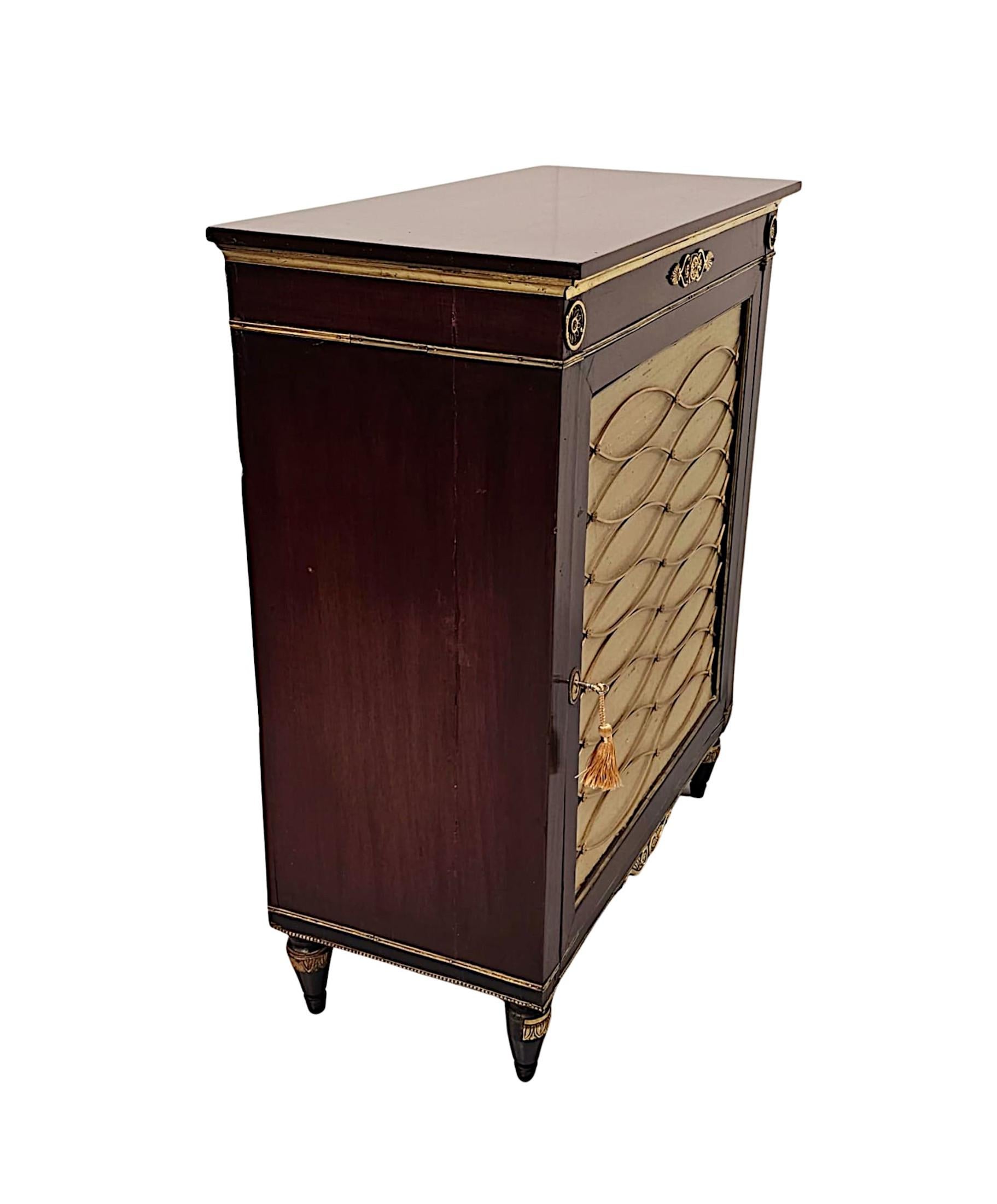 A very fine 19th Century mahogany single door cabinet superbly hand carved with beautifully rich patination, grain and of exceptional quality with finely cast brass grille and fitted with brass mounts throughout.  The well figured moulded top of