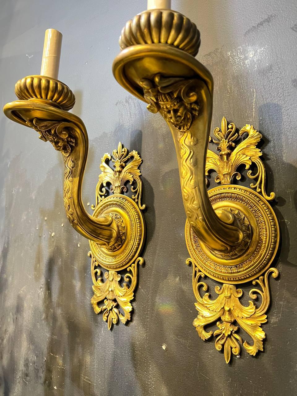 Pair of 19th century Caldwell gilt bronze neoclassic design one light sconces with comedy's faces. Unusual and impressive design 