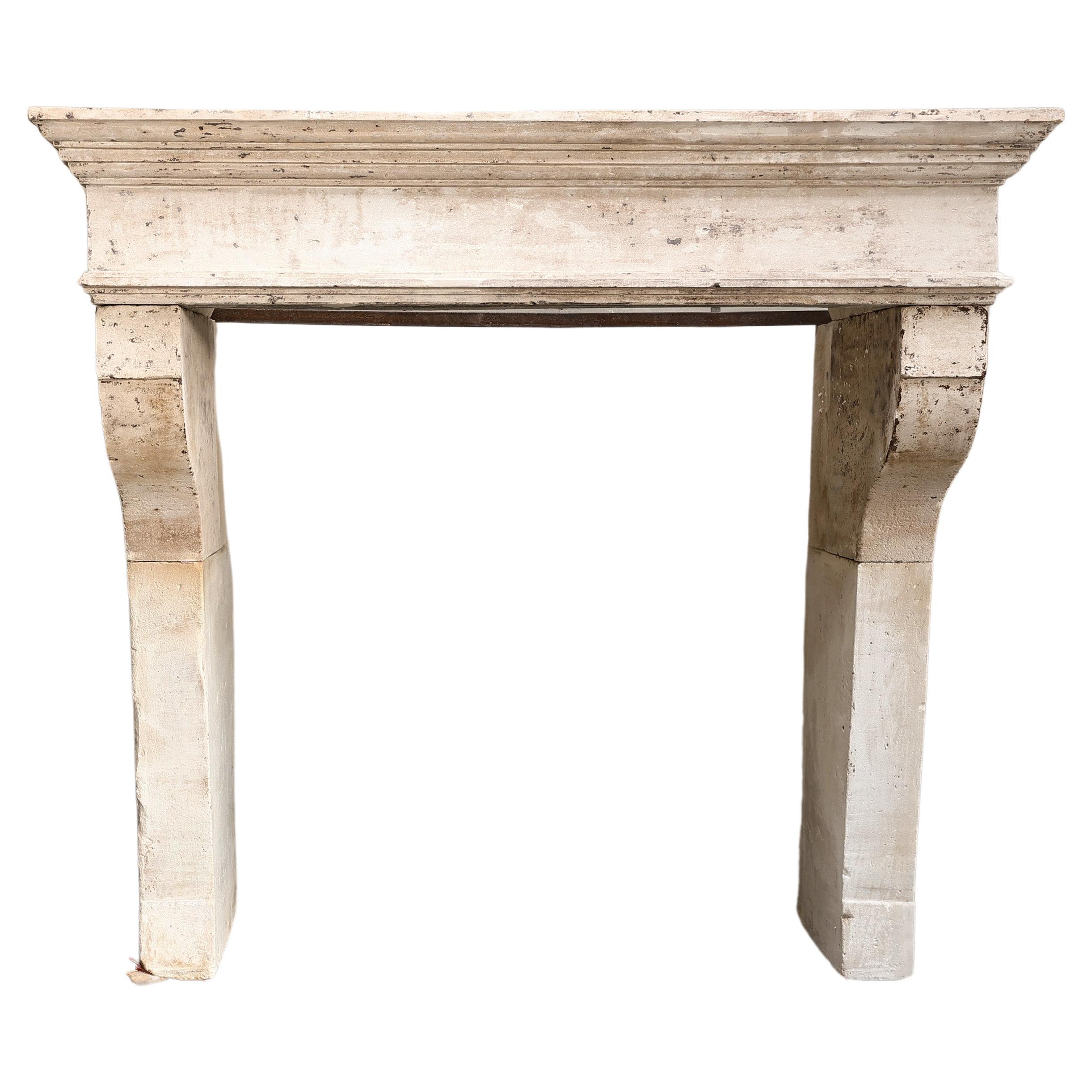 19th century Campagnarde style antique fireplace of French limestone