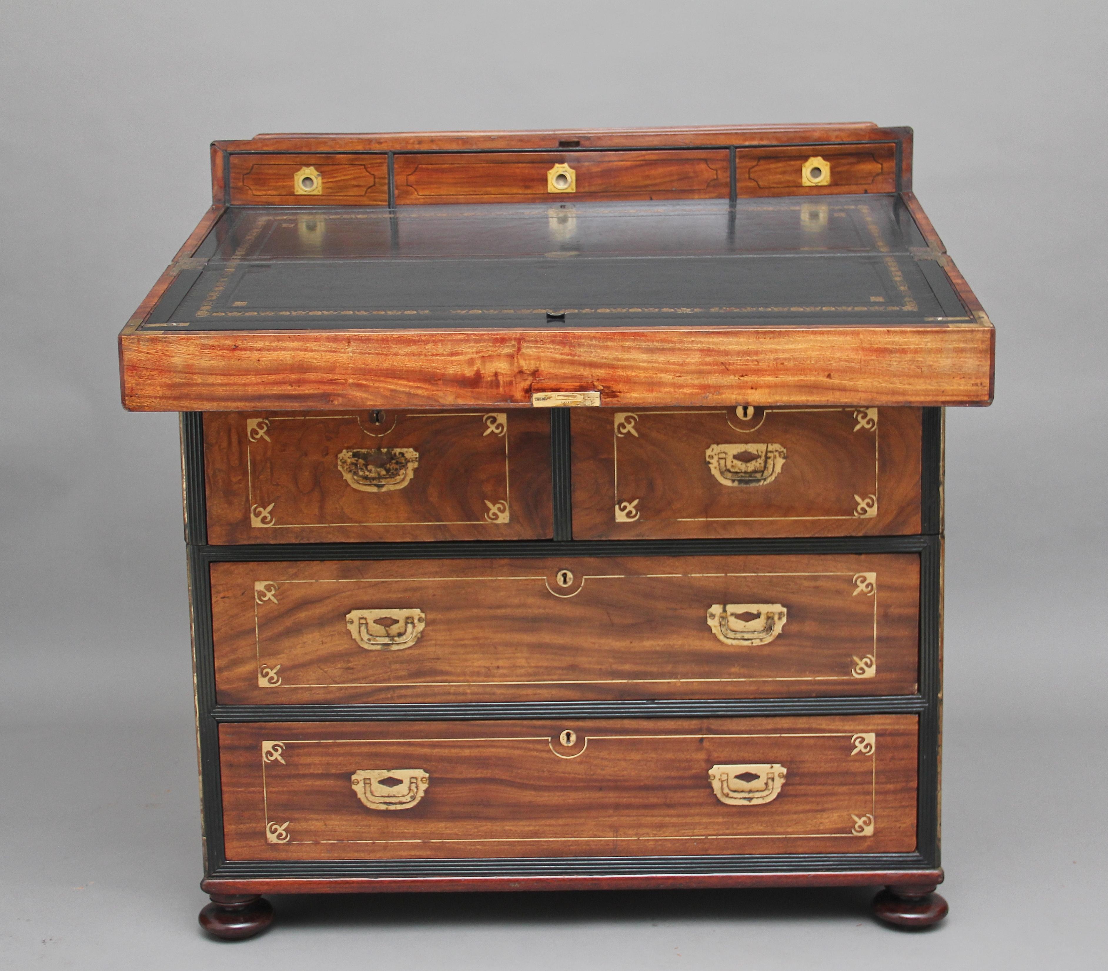 An extremely rare 19th century Anglo colonial padouk and brass inlaid desk or chest, the top folds over to reveal and black leather inset writing surface with gilt and blind tooled decoration, with three ebony inlaid drawers with brass handles, when