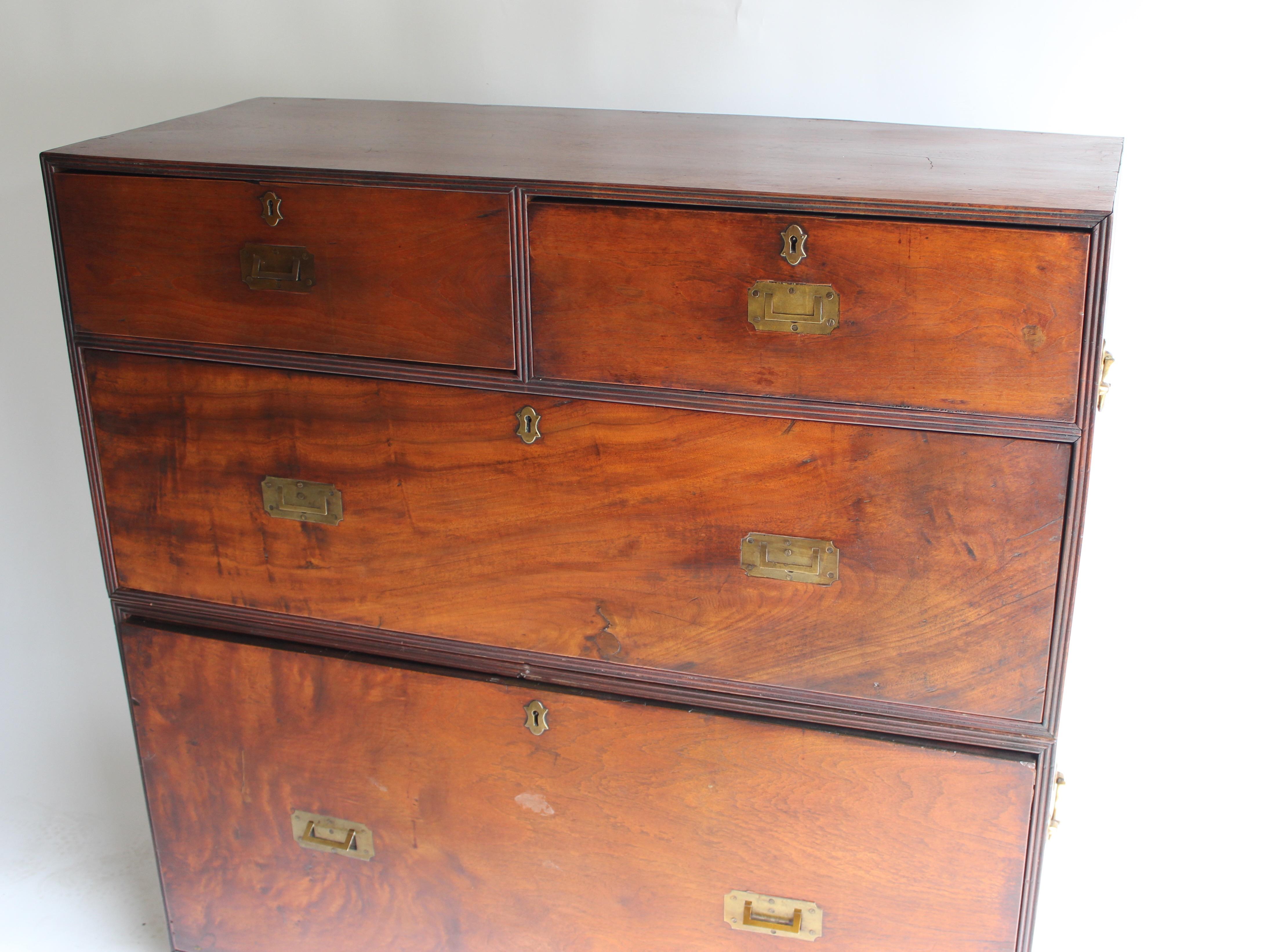 19th century two-part Campaign chest having four drawers... top right drawer is divided into two compartments, one of which has a small secret drawer.