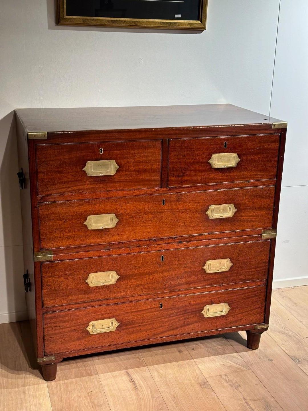 Beautiful small antique mahogany military campaign chest of drawers in perfect and completely original condition. Beautiful  patina. As usual with Campaign drawer cabinets, they consist of 2 parts and the drawer pulls lie flat. The legs can also be