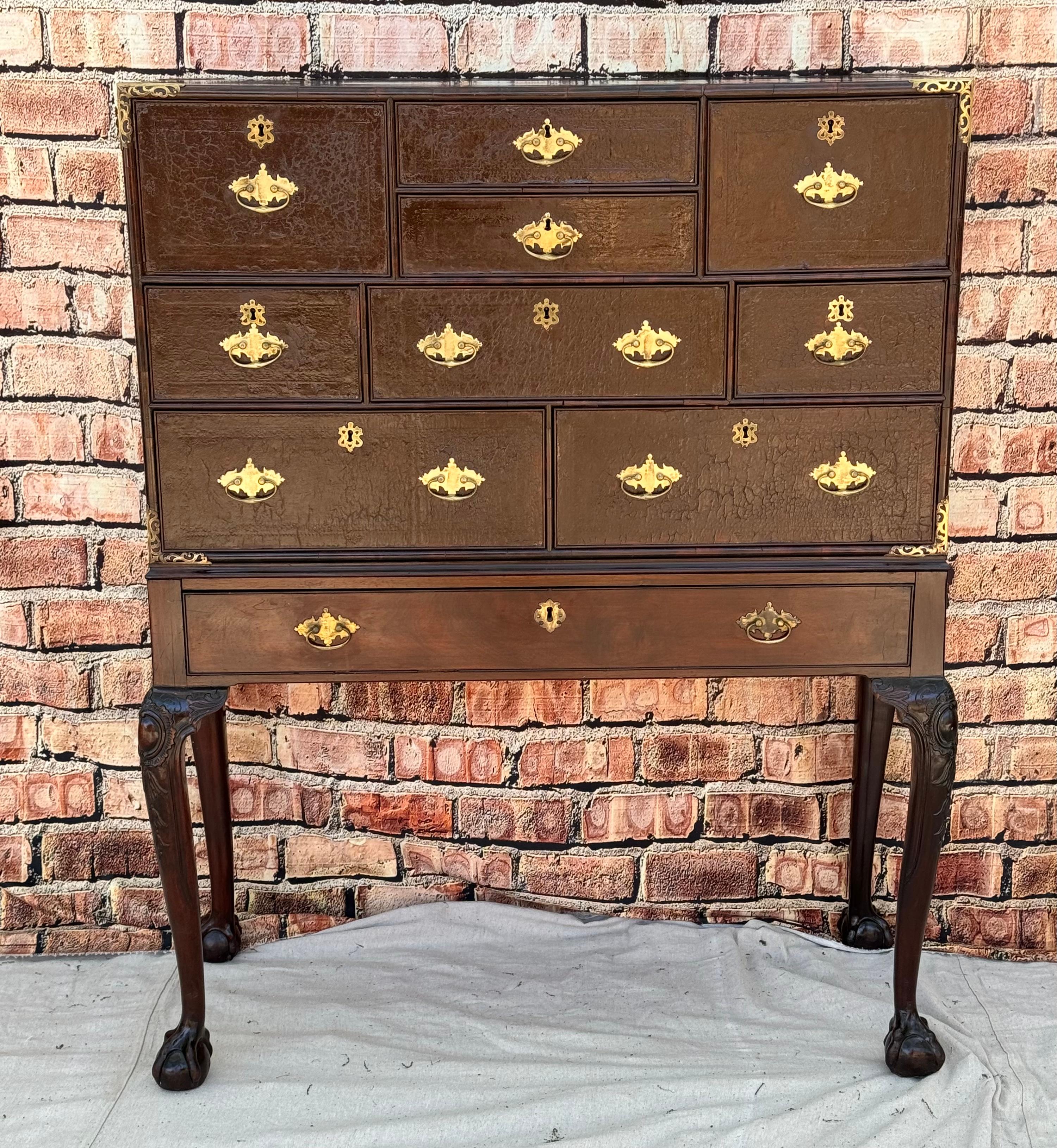 19th century Campaign desk or cabinet on stand. Stained leather drawer fronts opening to cubby holes on top and drawers below. The base with one drawer also. Standing on land legs with carved knees and ball and claw feet. The mahogany showing a nice