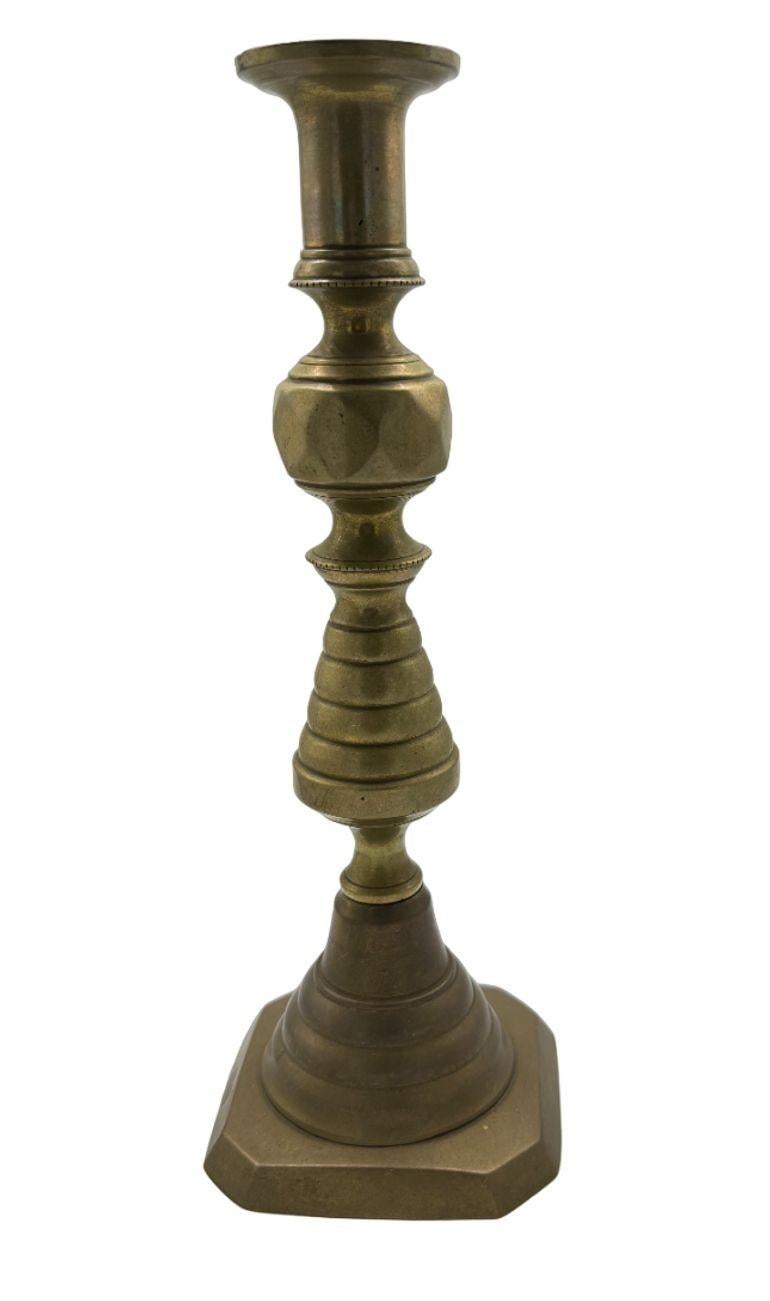 Step back in time with this captivating 19th Century Candlestick Holder from England. Crafted with meticulous attention to detail, this piece is a testament to the craftsmanship of a bygone era. Made in England during the 1800s, it carries the