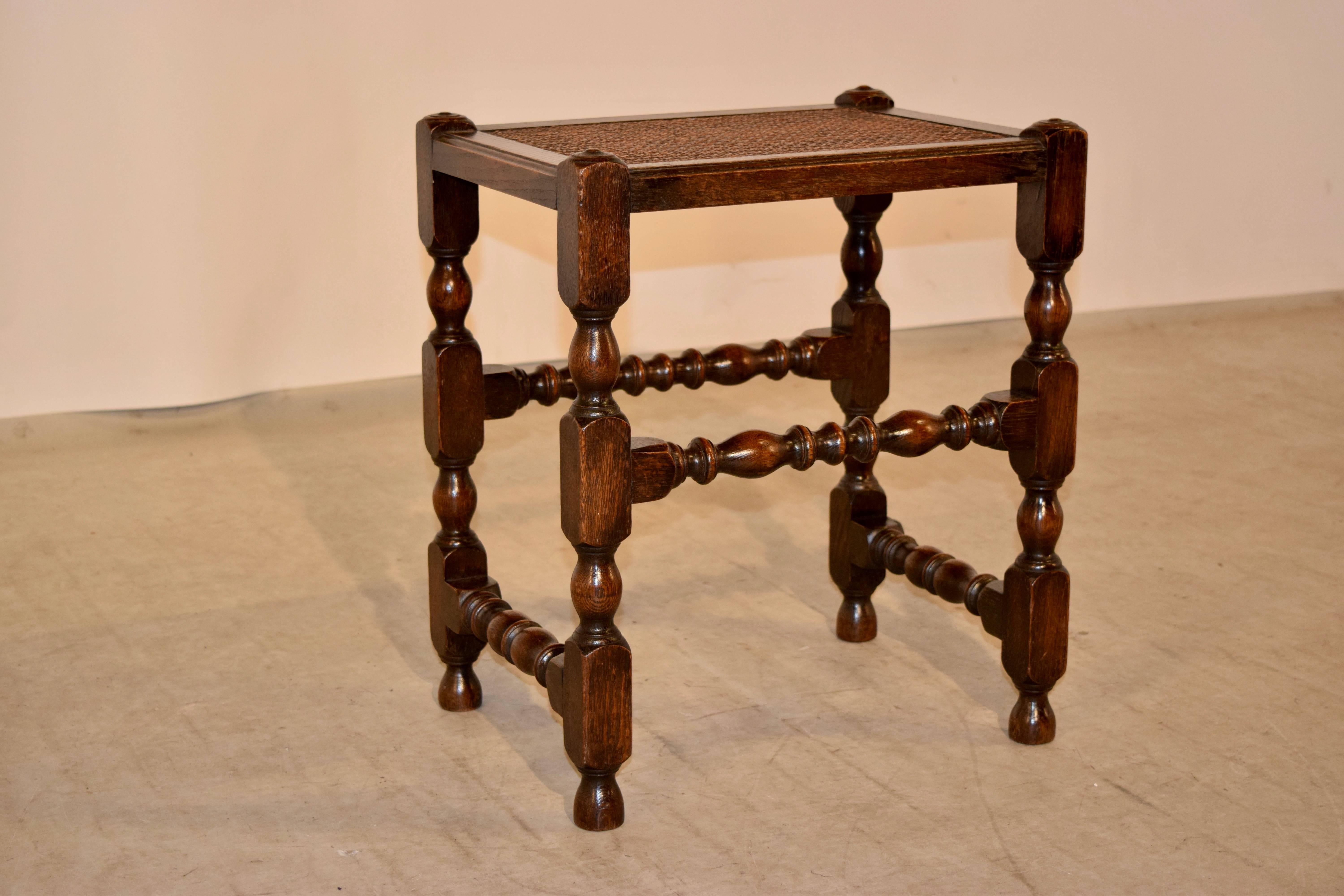 19th century English oak turned stool with original caned top.
 