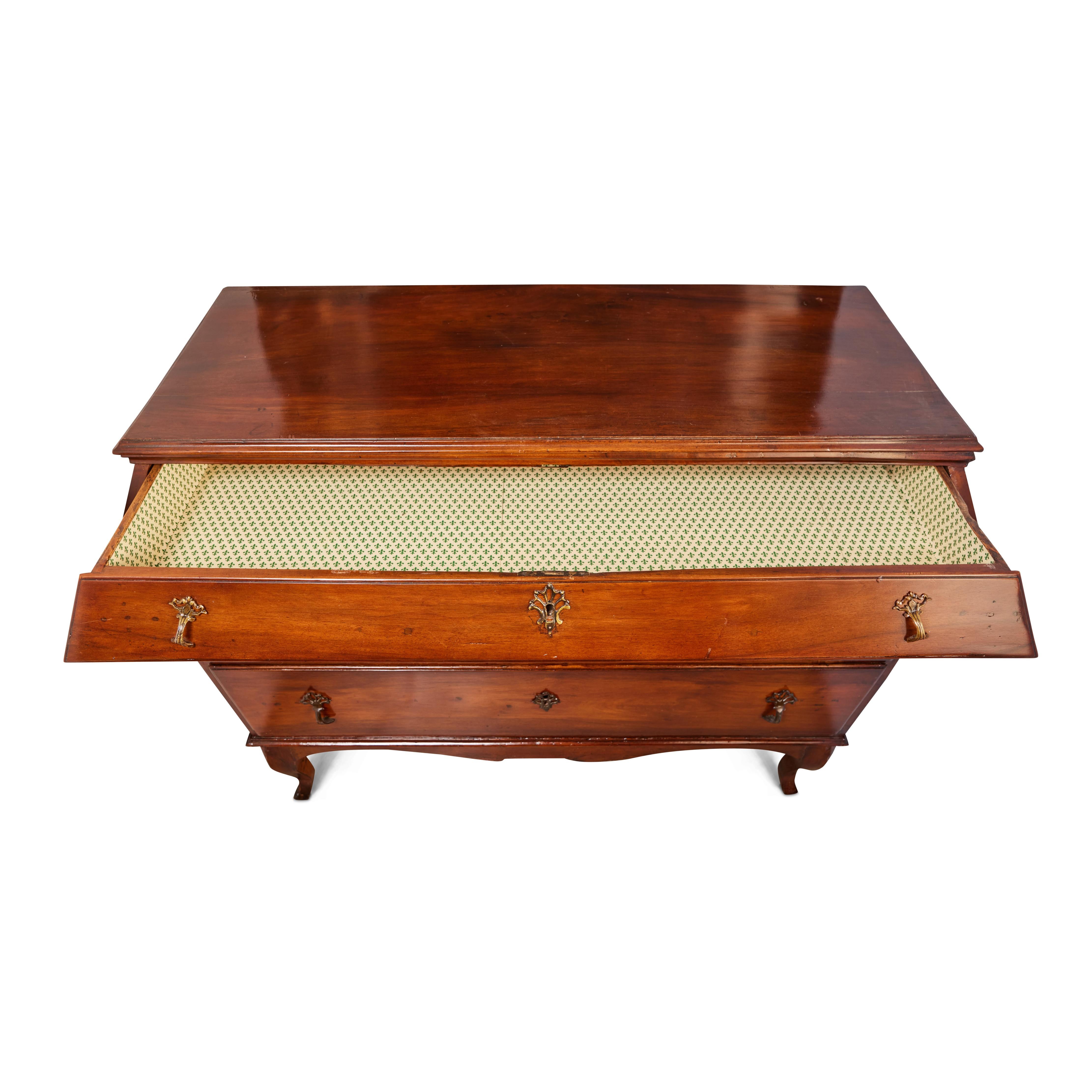A striking, Venetian, solid pearwood, canted edge, tapering three drawer commode. The whole above a scrolling apron and sitting on petite, cabriole legs. Original gilt bronze hardware.