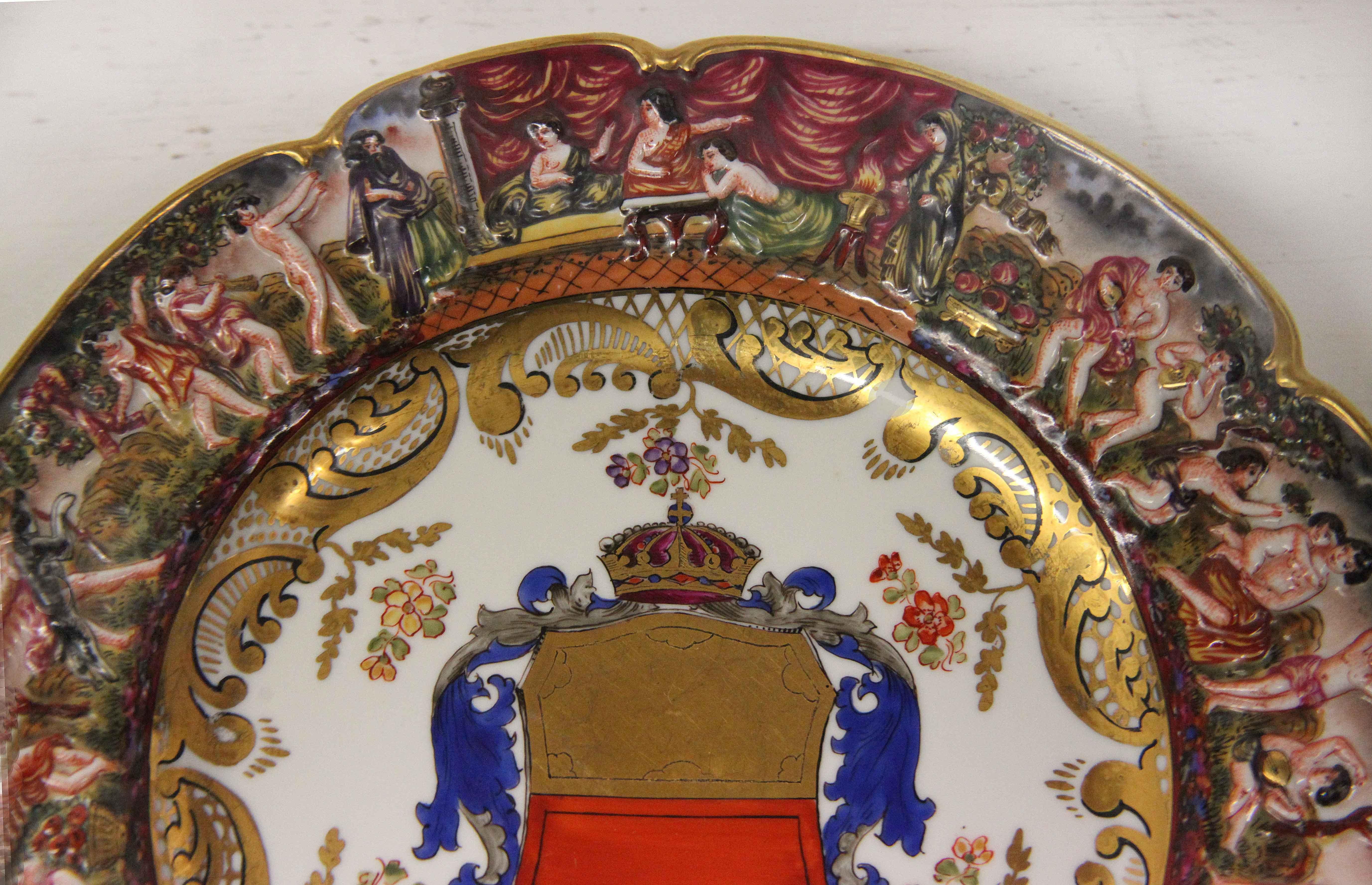 19the century Capodimonte plate, having shaped rim with border featuring classical scenes, coat of arms in center.