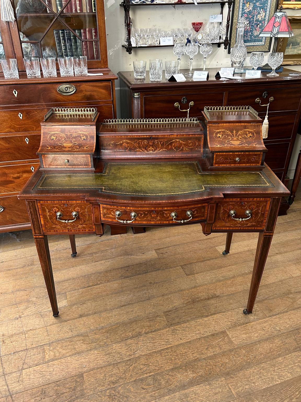 A very high quality 19th Century Carlton House Desk – Made by: Maple & Co. London Cabinet Makers for high quality furniture. The top has a brass gallery with two drawers and three lift up compartments, which include pigeon holes and ink wells. Below